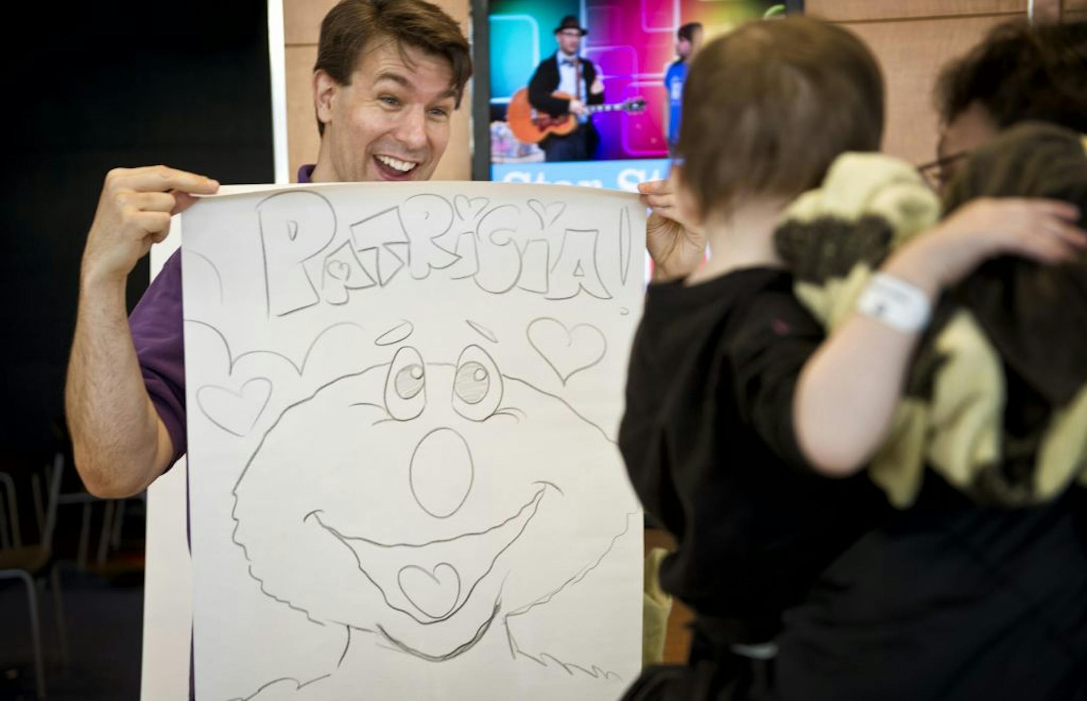Volunteer Jason Purple drew a cartoon character for a patient at Children's Hospital in Minneapolis as part of Give to the Max Day.