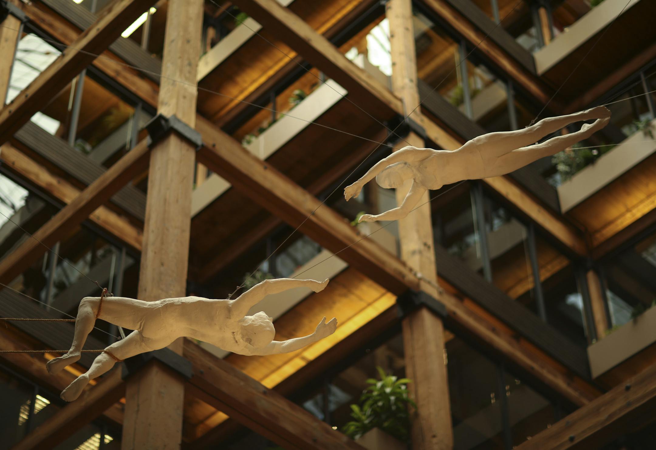 The sculpture “Circus Flyers” by George Segal soars in the west atrium of the Butler building.