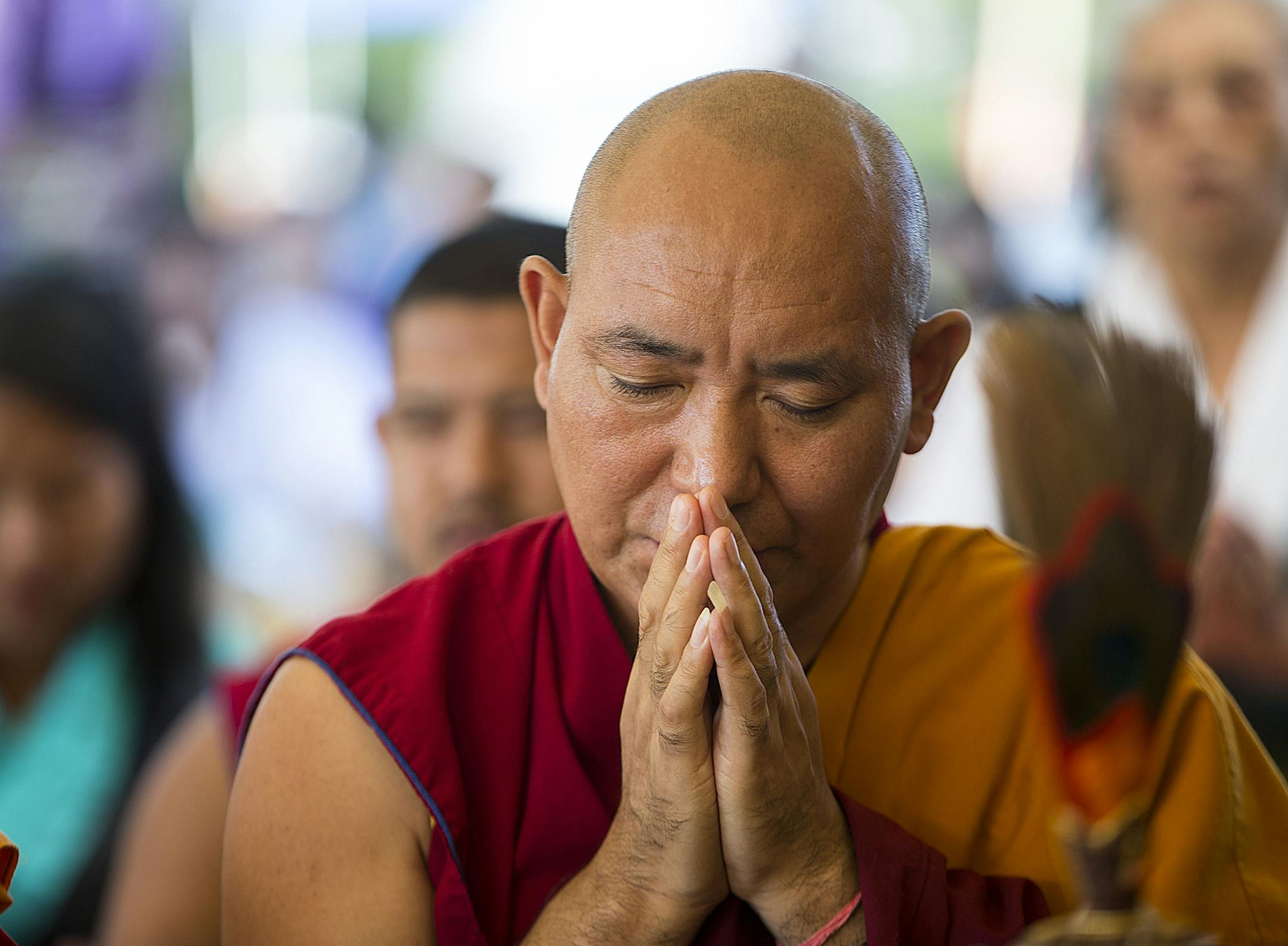 Abong Rinpoche, a Tibetan monk, prays during the ceremony. ] ALEX KORMANN • alex.kormann@startribune.com July 6, 2018 marked the 83rd birthday of the 14th Dalai Lama, the spiritual leader of Tibetan Buddhism. On July 7th, Tibetan communities from around the metro area came together at Boom Island Park to celebrate his birthday with traditional dances and prayers. Performers dressed in traditional garments and performed in a procession before monks led the community in prayer.