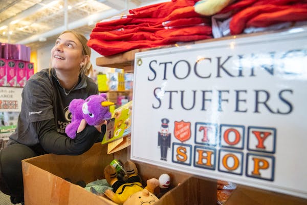 Jayne Witzany, a volunteer, picked out toys Wednesday during the first day of the Salvation Army Toy Shop at Woodland Hills Church in St. Paul.