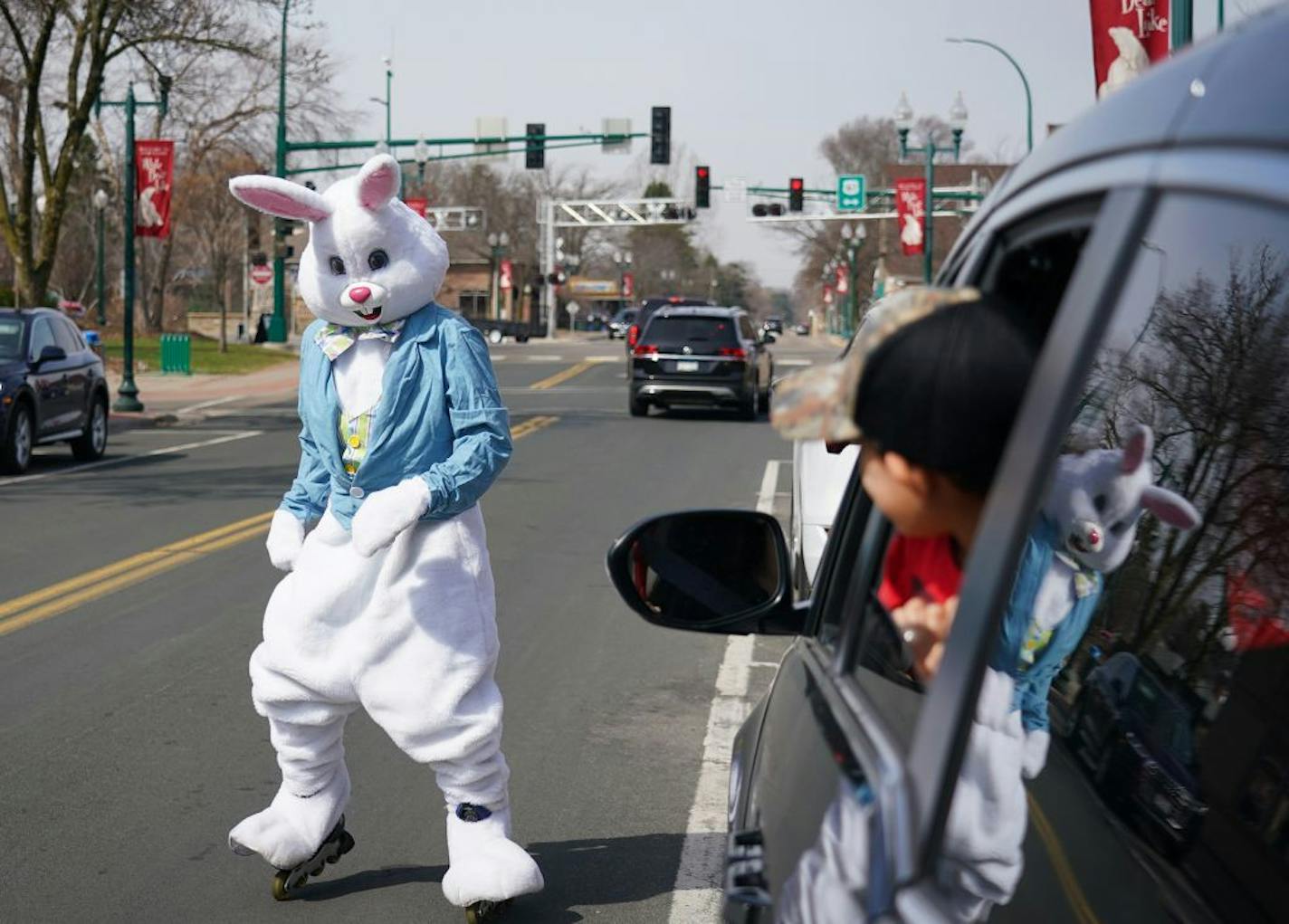 A young passenger checked out the Easter bunny in White Bear Lake on April 11, after Easter events were canceled due to the pandemic. Health officials discourage those from different households from riding in an enclosed space like a car, but say cracking open a window can help dilute the concentration of droplets and aerosols in a vehicle.