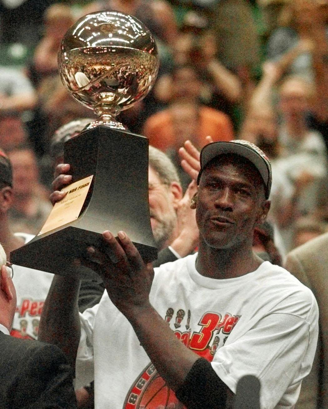 Michael Jordan holds the MVP trophy after the Bulls defeated the Jazz 87-86 in Game 6 of the 1998 NBA Finals in Salt Lake City.