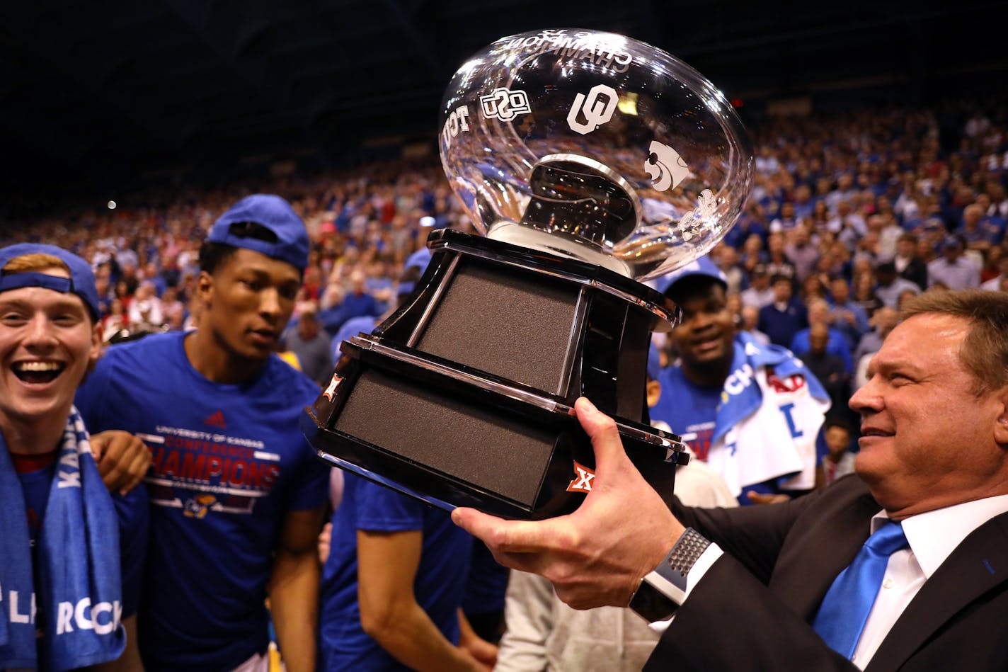 Head coach Bill Self of the Kansas Jayhawks hands the the Big 12 Championship Trophy to players after Kansas defeated the TCU Horned Frogs to win the game at Allen Fieldhouse on March 04, 2020 in Lawrence, Kansas. (Jamie Squire/Getty Images/TNS)