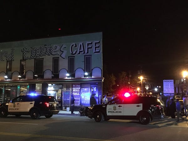 Minneapolis police responding to a report of shots fired Friday night in the Cedar-Riverside area found a man dead in a car behind Hard Times Cafe.