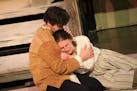 Karl (Dawson D. Ehlke) comforts Ruselka (Elizabeth Efteland) after their baby is taken. (Matt Berdahl)