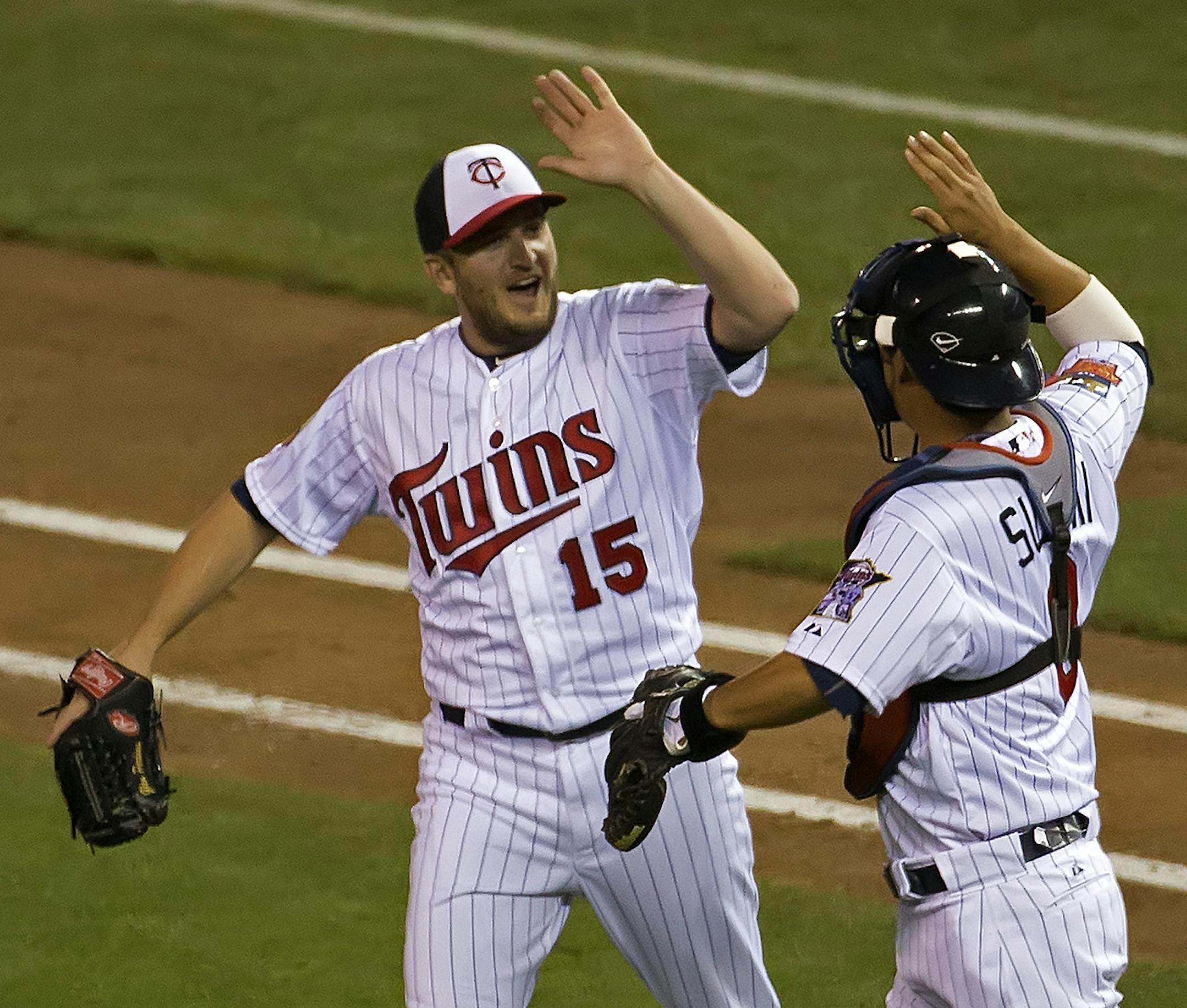 Twins closer Glen Perkins got the save and gets a high five from Twins catcher Kurt Suzuki at the 2014 MLB All Star Game, Target Field.