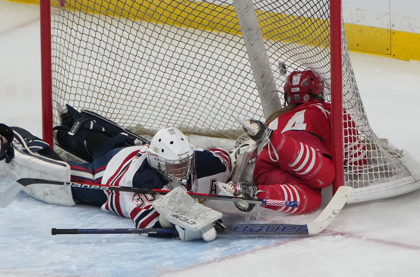 Luverne forward Kamryn Van Batavia (14) crashes in to the net after getting a shot off against Orono goaltender Celia Dahl (30) in the third period at Xcel Energy Center in St. Paul, Minn., on Wednesday, Feb. 22, 2023. Orono defeated Luvurne 6-0 in a Class 1A State Hockey Tournament semifinal. ] SHARI L. GROSS • shari.gross@startribune.com