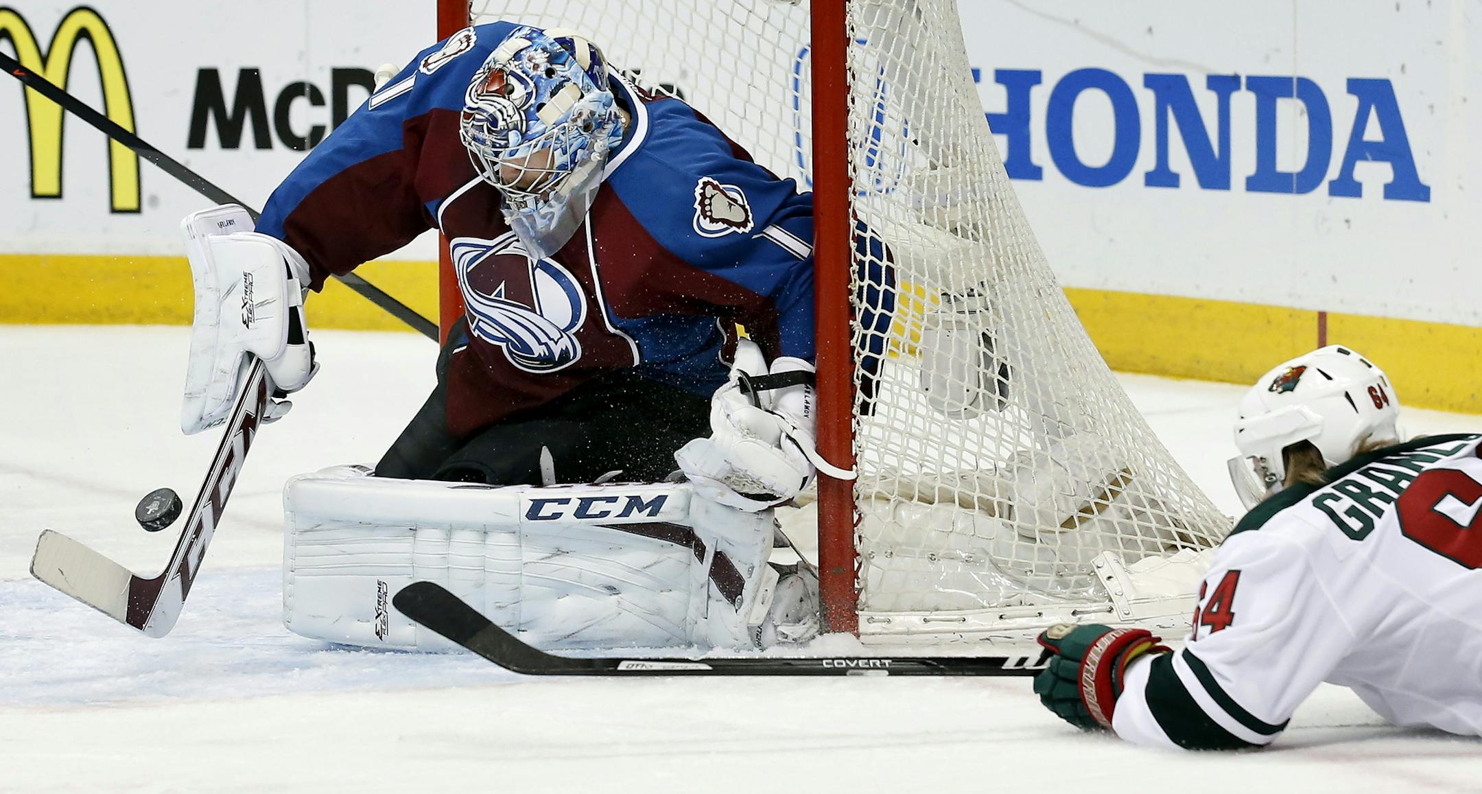 Mikael Granlund (64) attempted a shot on Colorado goalie Semyon Varlamov (1) in the first period. ] CARLOS GONZALEZ cgonzalez@startribune.com - April 26, 2014, Denver, Colorado, Pepsi Center, NHL, Minnesota Wild vs. Colorado Avalanche, Stanley Cup Playoffs round 1, Game 5