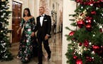 President Barack Obama and first lady Michelle Obama arrive for a reception to honor recipients of the 2016 Kennedy Center Honors in the East Room of 