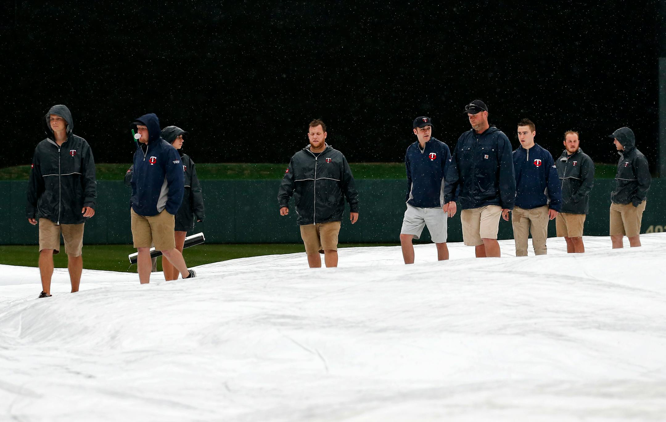 Members of the Target Field grounds crew surveyed the field as it rained before the start of Tuesday night�s game between the Minnesota Twins vs. Boston Red Sox. ] CARLOS GONZALEZ cgonzalez@startribune.com, May 26, 2015, Minneapolis, MN, Target Field, MLB, Minnesota Twins vs. Boston Red Sox