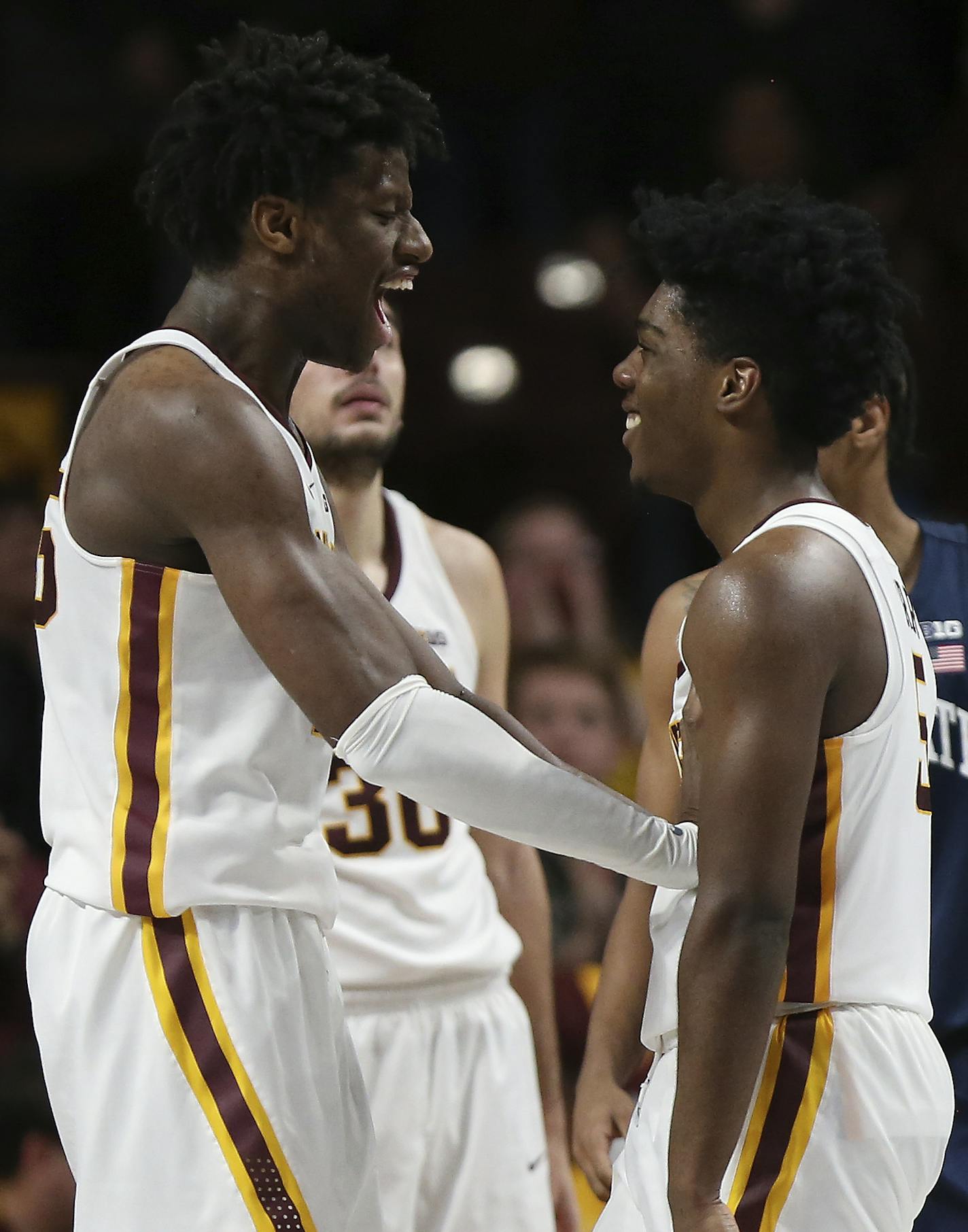 Minnesota's Daniel Oturu, left, celebrates with Marcus Carr, right, after Carr scored a 3-pointer against Penn State during the second half of an NCAA college basketball game Wednesday, Jan. 15, 2020, in Minneapolis. Minnesota won 75-69. (AP Photo/Stacy Bengs)