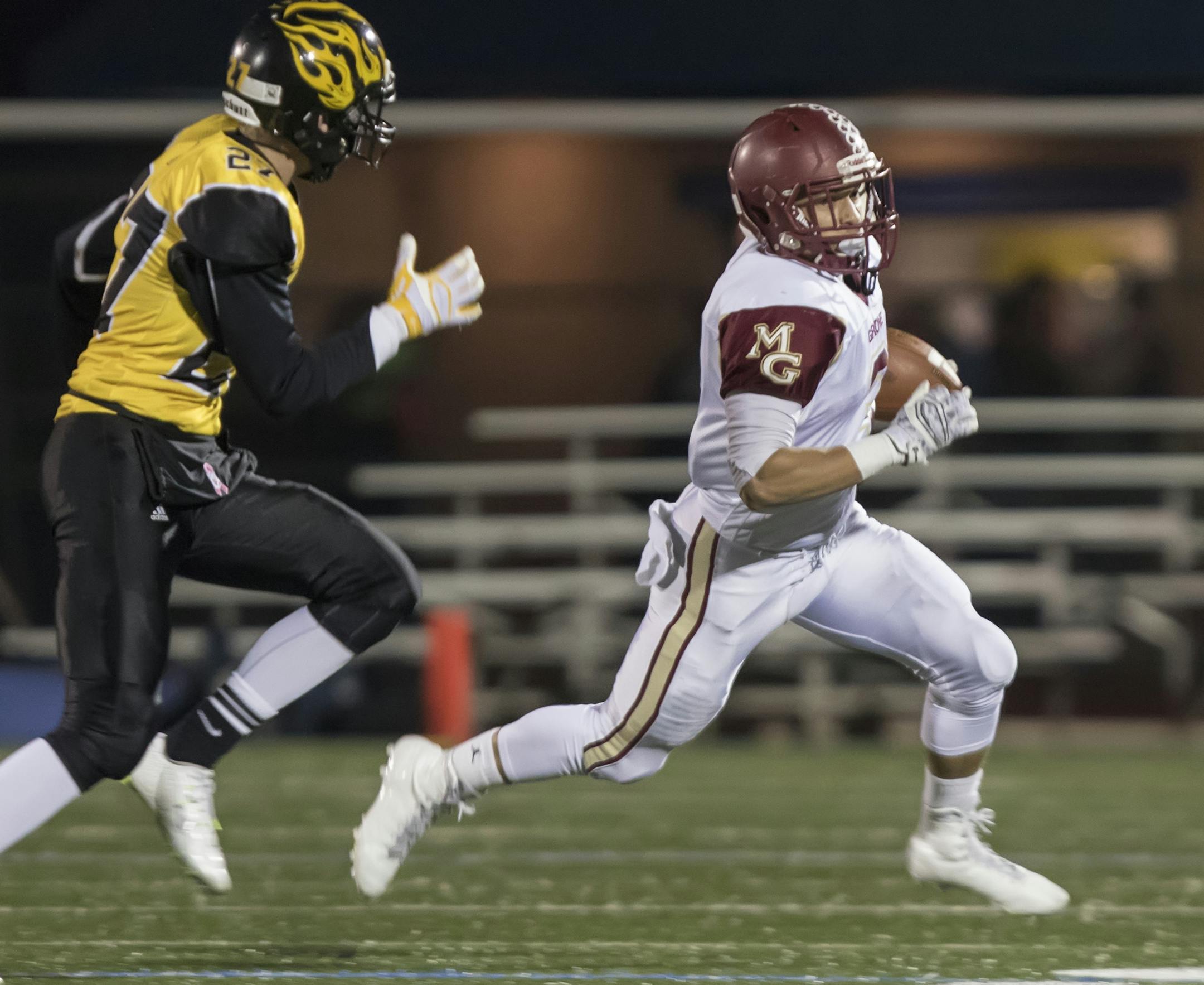 Maple Grove running back Isaac Collins (3) beats Burnsville defensive back Jared Gemunden (27) to the corner as the Burnsville Blaze faced the Maple Grove Crimson in MSHSL Football playoffs at Hopkins High School on October 30, 2015. ] MATT BLEWETT &#xef; matt@mattebphoto.com - October 30, 2015, Hopkins, MN, Burnsville High School, Maple Grove Crimson, Prep Football, Burnsville Blaze vs. Maple Grove Crimson