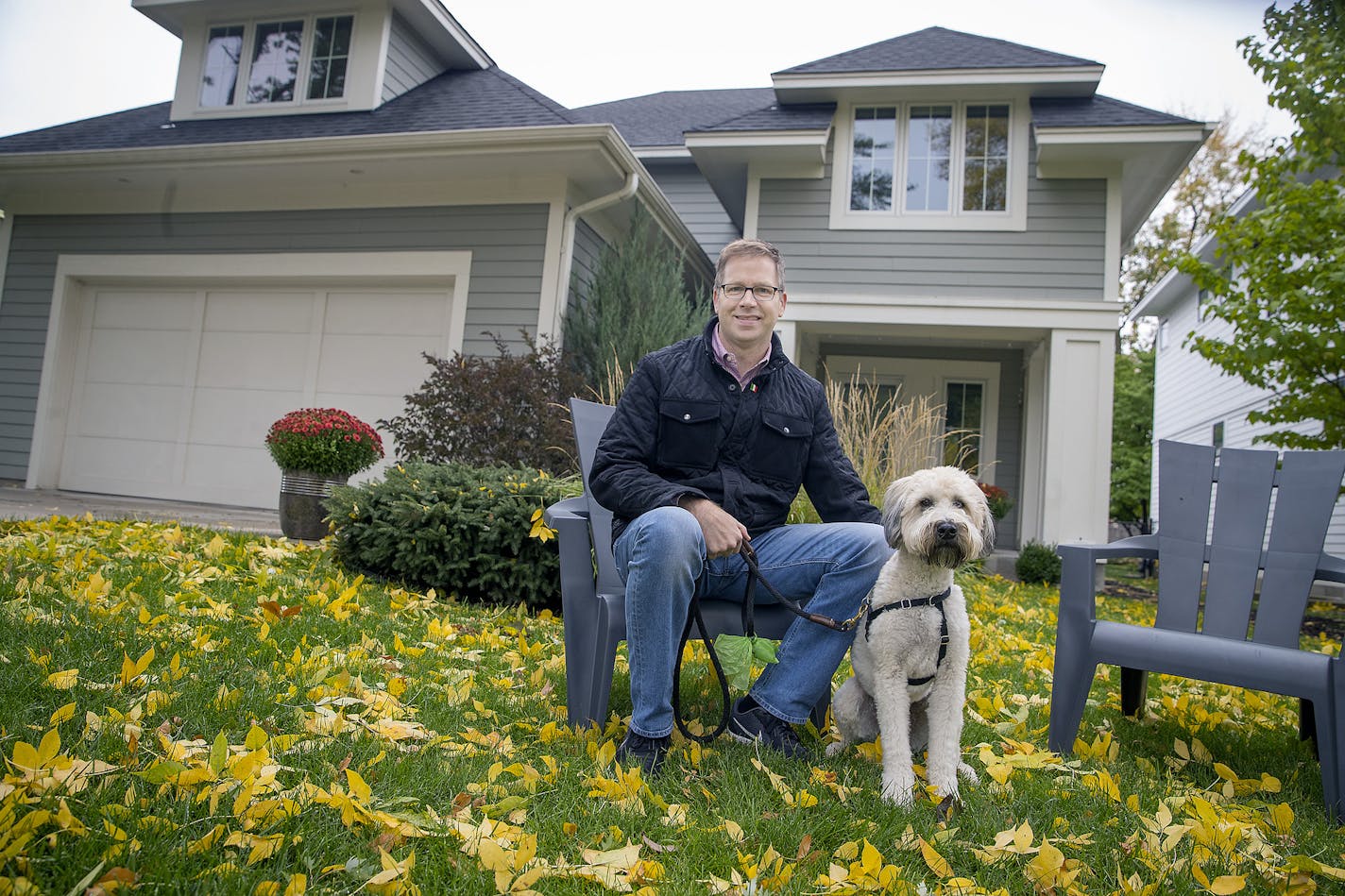 Andy Porter, owner of the building company Refined, sat with his dog Hamilton in front of the house he built for himself and his family in the Pamela Park Neighborhood.