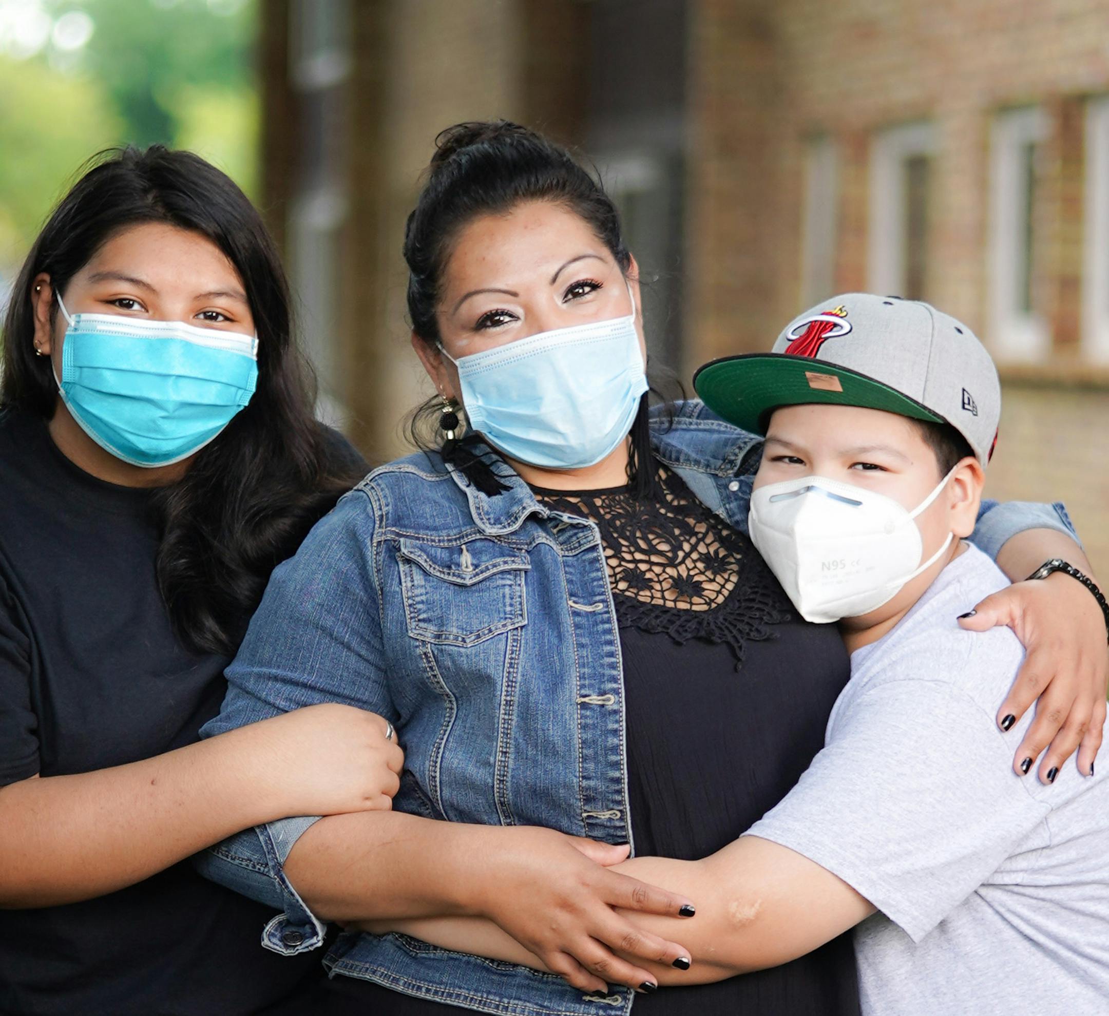 Prisly Cerna, a janitor at Macy's in Burnsville, worries that the mask and gloves she is supplied may not be enough to protect her and her children, Ashley, 16, and Brandon, 12.