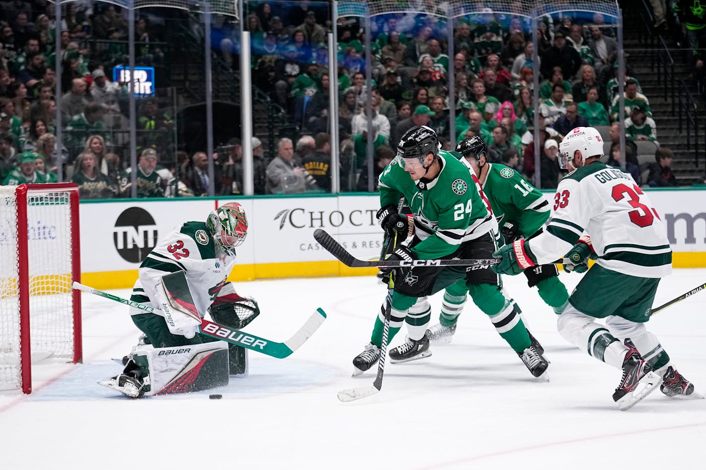 Minnesota Wild goaltender Filip Gustavsson (32) blocks a shot by Dallas Stars center Roope Hintz (24) as Wild defenseman Alex Goligoski (33) watches the play during the first period of an NHL hockey game Wednesday, Feb. 8, 2023, in Dallas. (AP Photo/Tony Gutierrez)