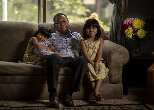 "It was a very tough thing to take in," said Dr. Nyan Pyae, seen in his Roseville home with his twins, May Hninpwint, left, and Mya Moesett. "I missed