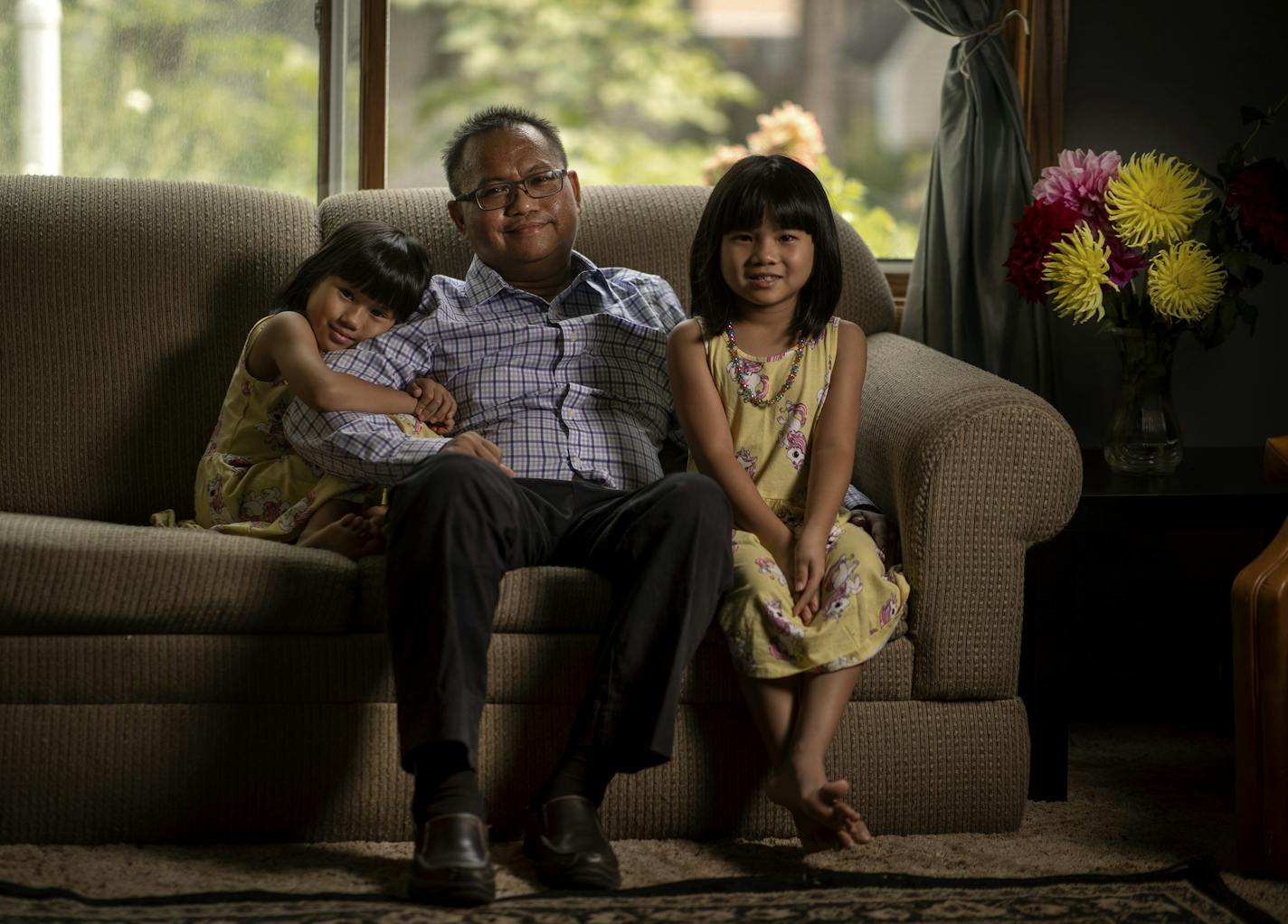 "It was a very tough thing to take in," said Dr. Nyan Pyae, seen in his Roseville home with his twins, May Hninpwint, left, and Mya Moesett. "I missed Father's Day. I missed my daughters' birthday."