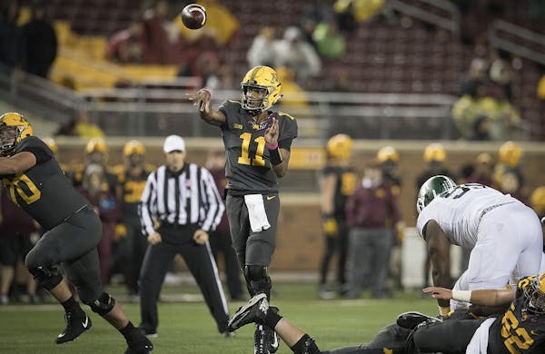 Minnesota's quarterback Demry Croft passed the ball to wide receiver Tyler Johnson for a touchdown during the fourth quarter as the Gophers took on Mi