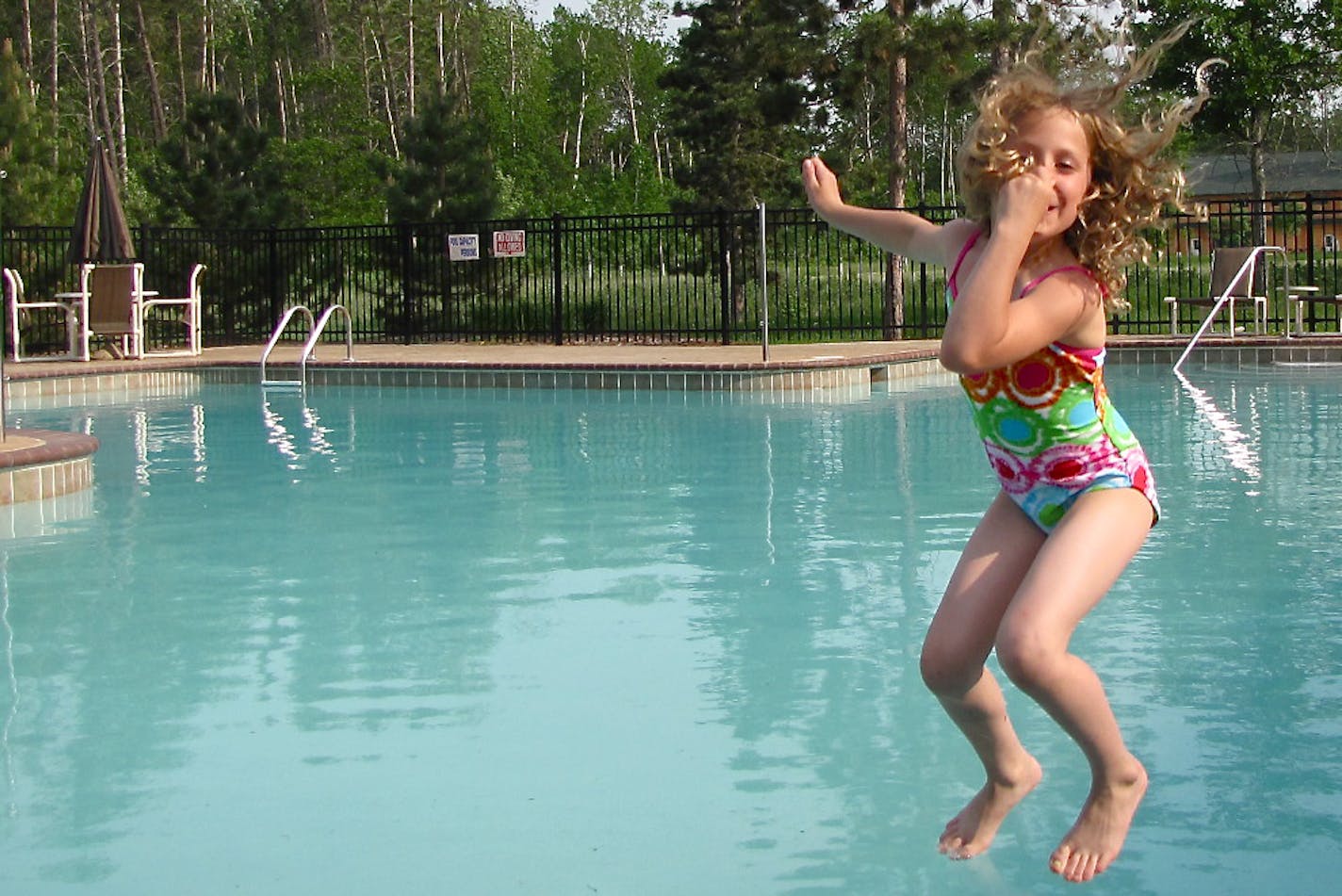 Kylie McClintick jumps into the pool at Clamshell Beach Resort, which also has a beach area.