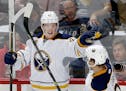 Jack Eichel of the Buffalo Sabres celebrated with teammate Johan Larsson, right, after scoring a shorthanded goal against the Wild in the third period