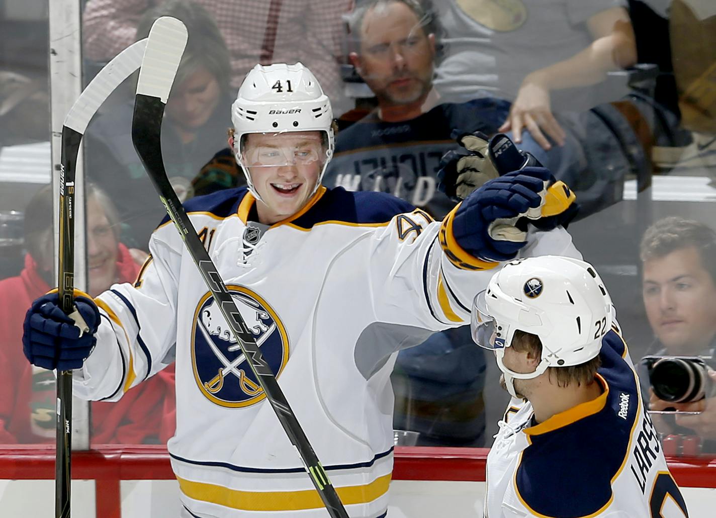 Jack Eichel of the Buffalo Sabres celebrated with teammate Johan Larsson, right, after scoring a shorthanded goal against the Wild in the third period of an exhibition game Monday.