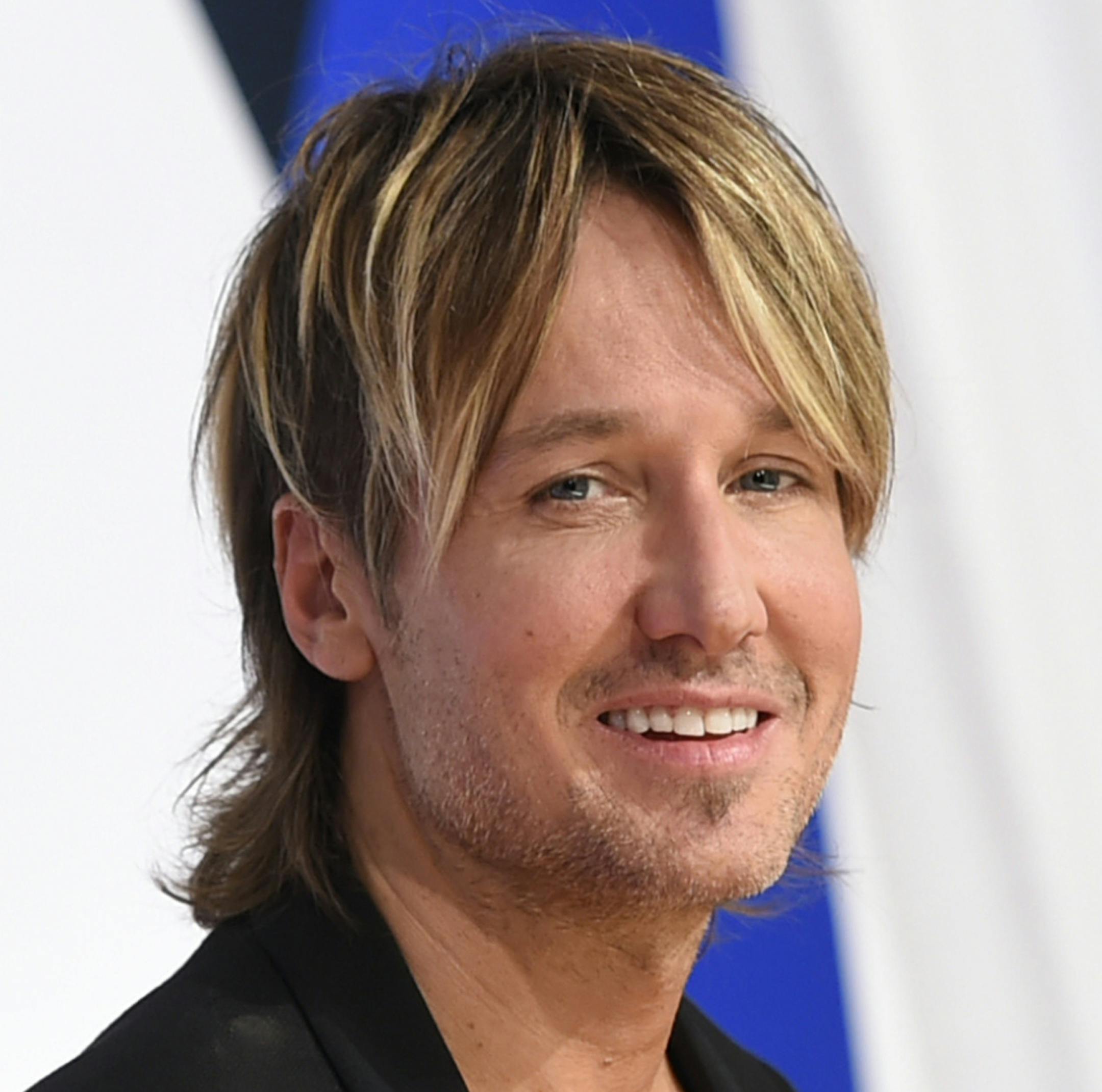 FILE - In a Wednesday, Nov. 4, 2015 file photo, Keith Urban arrives at the 49th annual CMA Awards at the Bridgestone Arena, in Nashville, Tenn. Urban is mourning the death of his father, Bob Urban, at the age of 73. Urban said in a statement released late Sunday, Dec. 6, 2015, that his dad died on Saturday after a long battle with cancer. (Photo by Evan Agostini/Invision/AP)