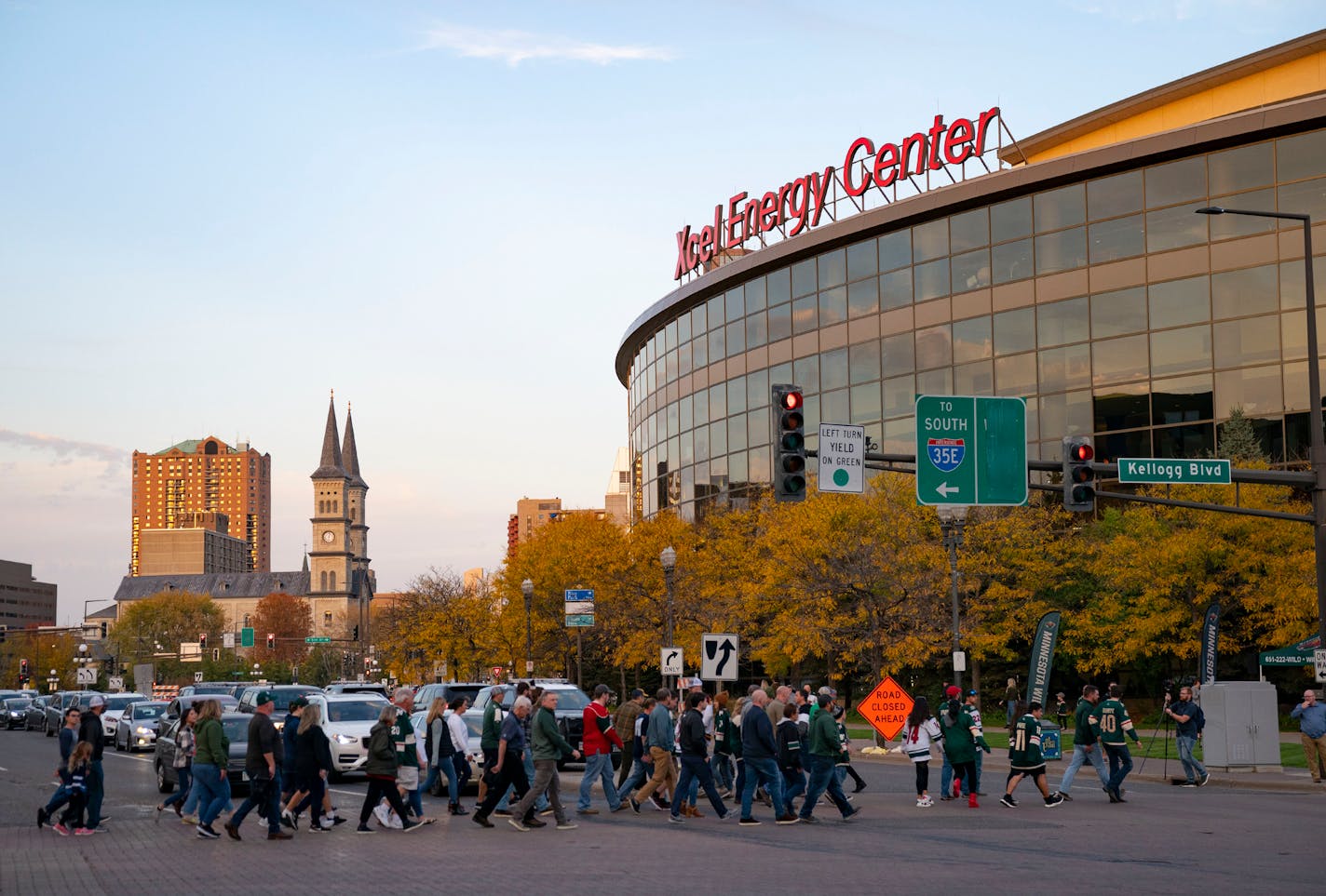 Minnesota Wild fans cross Seventh St. SW. ahead of a Minnesota Wild game Tuesday, Oct. 19, 2021 outside Xcel Energy Center in St. Paul, Minn. The Wild took on the Winnipeg Jets in their home opener. ]