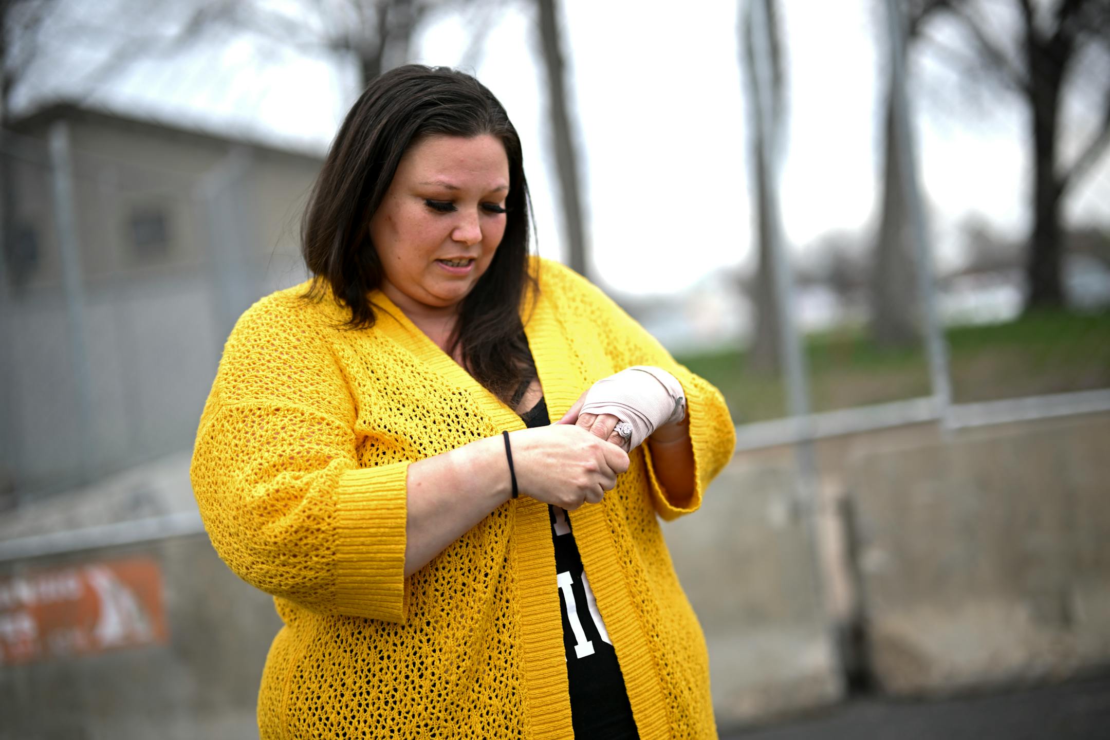Katie Wright holds her hand on her injured wrist before a press conference Thursday, May 5, 2022 outside the Brooklyn Center Police Station.