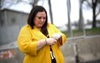 Katie Wright holds her hand on her injured wrist before a press conference Thursday, May 5, 2022 outside the Brooklyn Center Police Station.