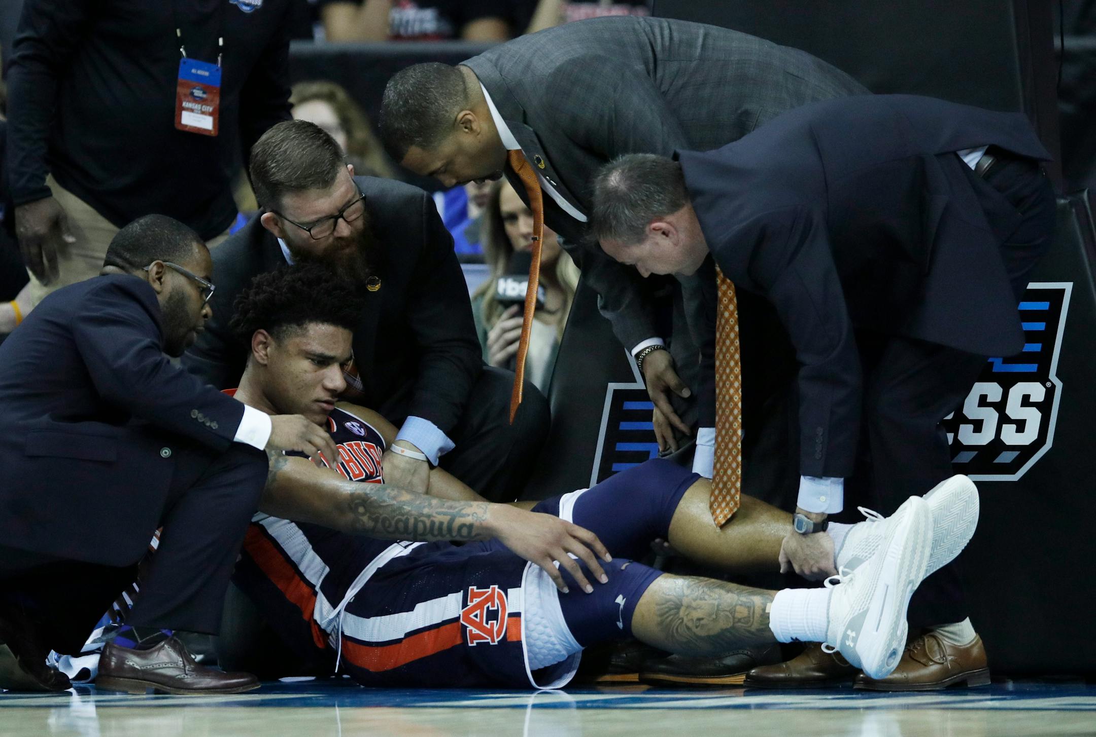 Trainers assist Auburn's Chuma Okeke after he was injured during the second half vs. North Carolina. Okeke tore the ACL in his knee and will undergo surgery.