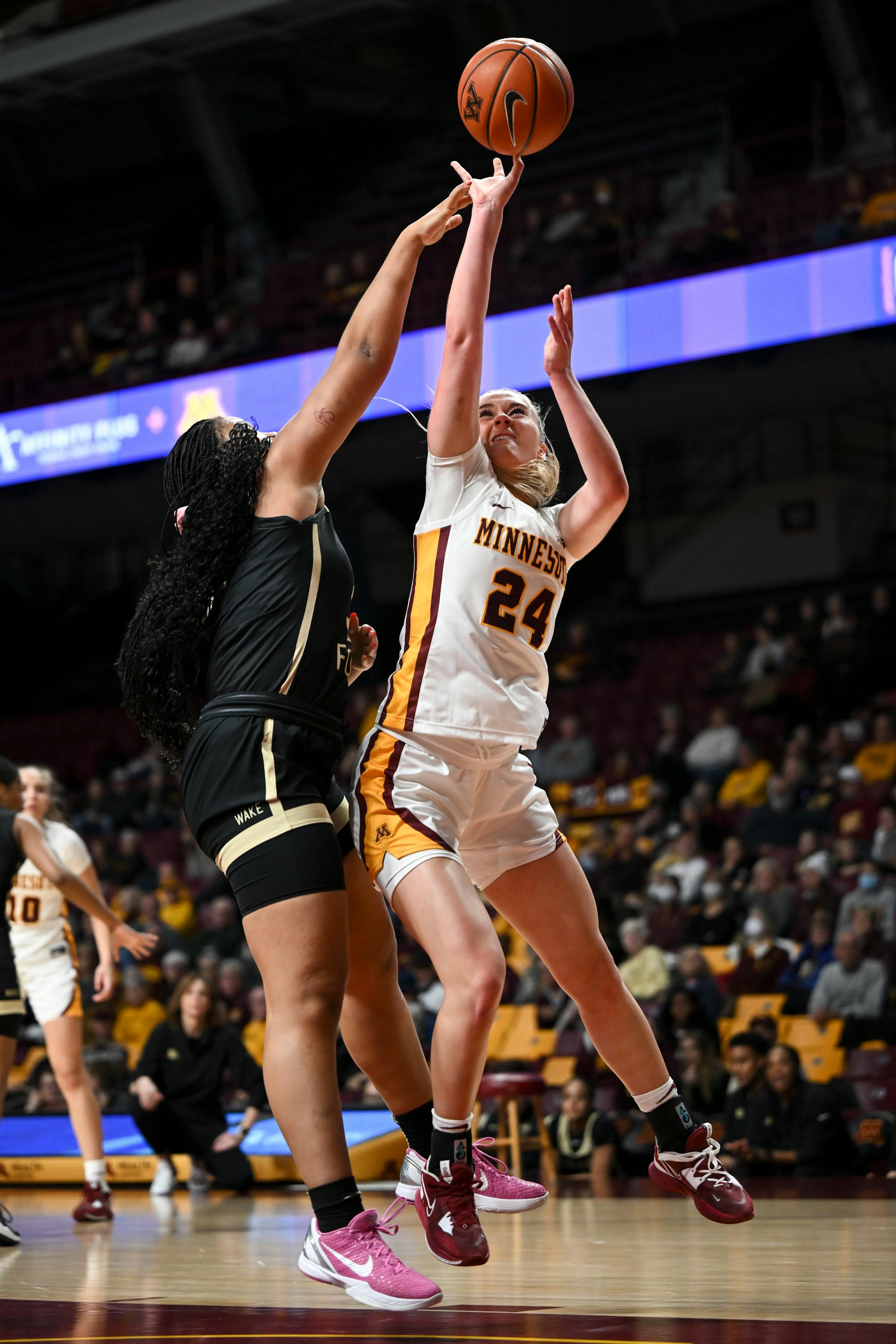 Minnesota Gophers forward Mallory Heyer (24) is foulded by Wake Forest guard Alexandria Scruggs (32) during the first half.