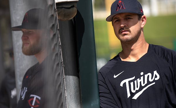 Tyler Mahle, right, and Blayne Enlow watched as the Twins went through workouts Thursday in Fort Myers, Fla.