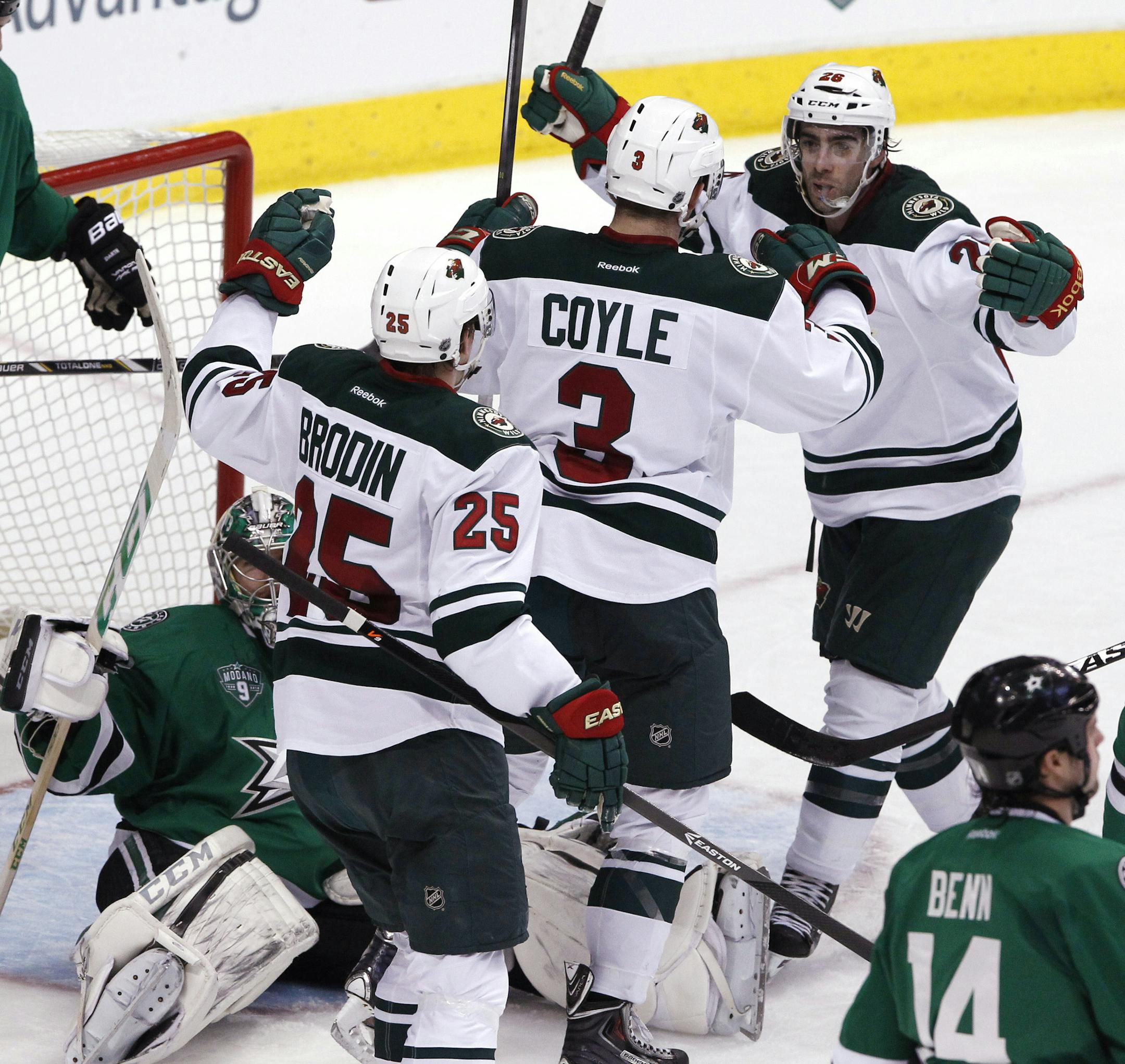 Minnesota Wild's Jonas Brodin (25), Charlie Coyle (3), and Matt Moulson (26) celebrate Coyle's goal in the second period during an NHL hockey game against the Dallas Stars in Dallas on Saturday, March 8, 2014. (AP Photo/Richard W. Rodriguez)