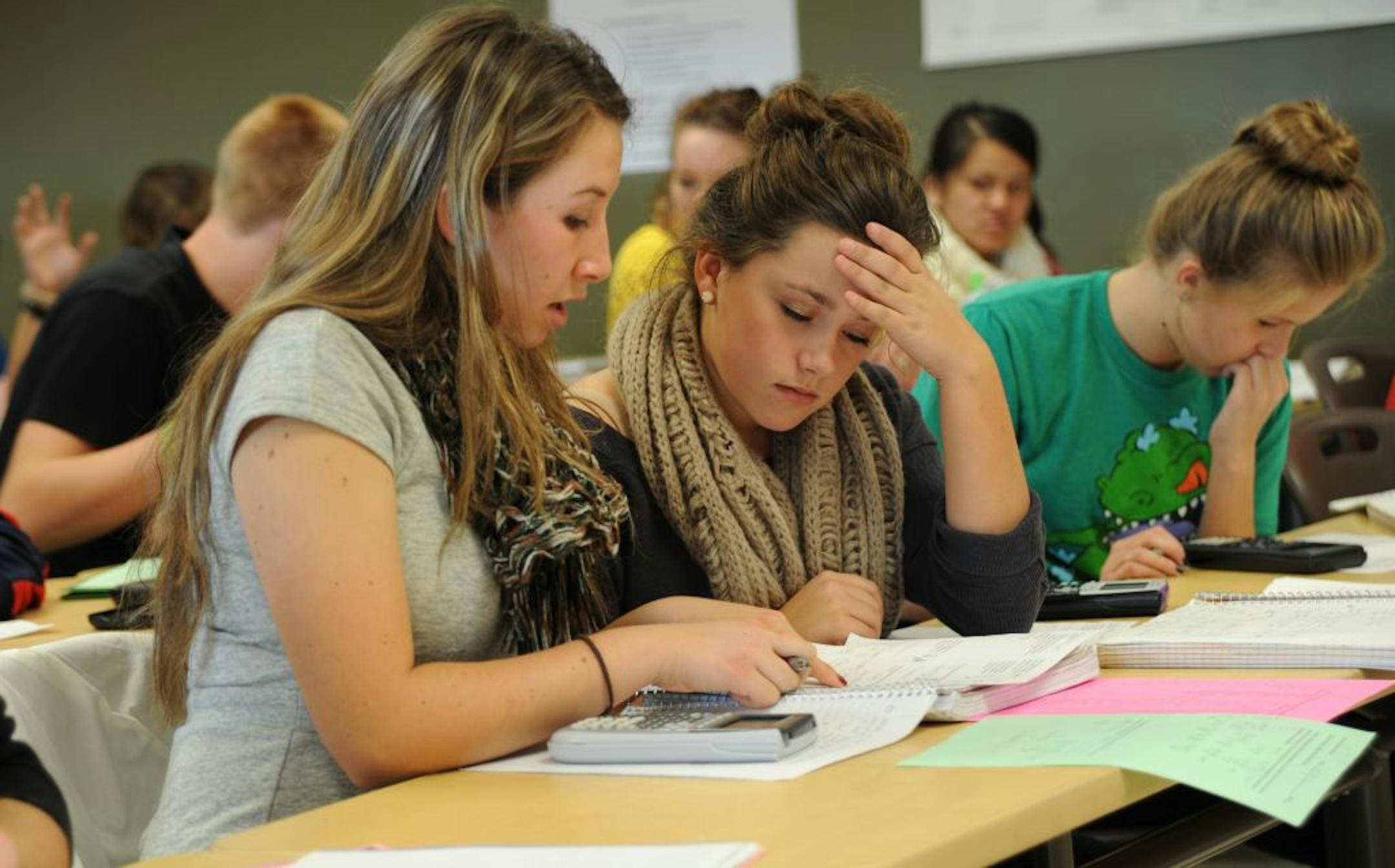 Cassidy Brewin, left, a senior at Chanhassen High School, helps her friend, McKenna Risch, with a problem in their AP physics class.