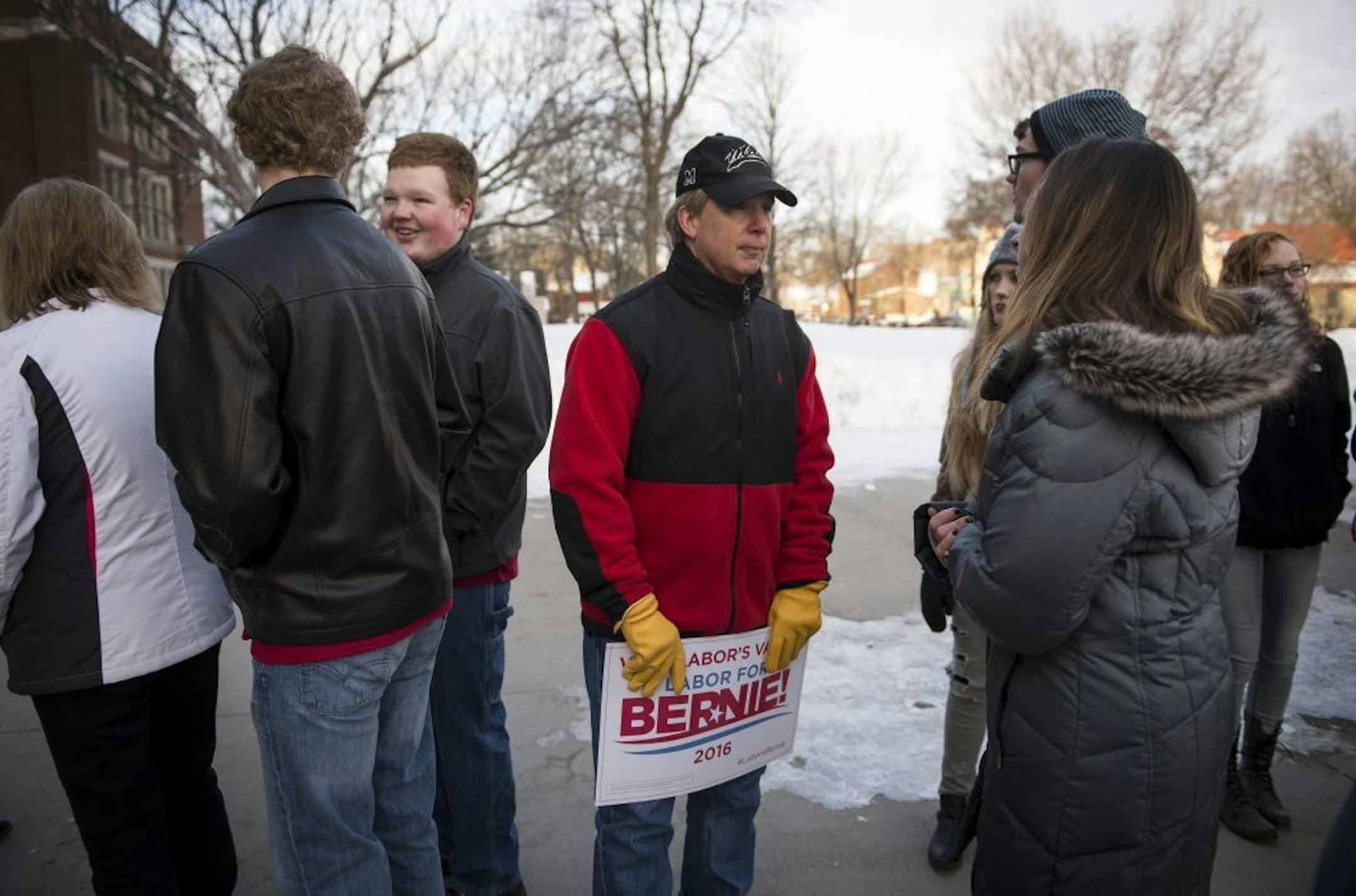 Kevin Thompson, center, a laid off steel worker with United Taconite of Eveleth, waited in line outside Hibbing High School to hear Bernie Sanders speak Friday morning. Thompson worked for United Taconite for 30 years.