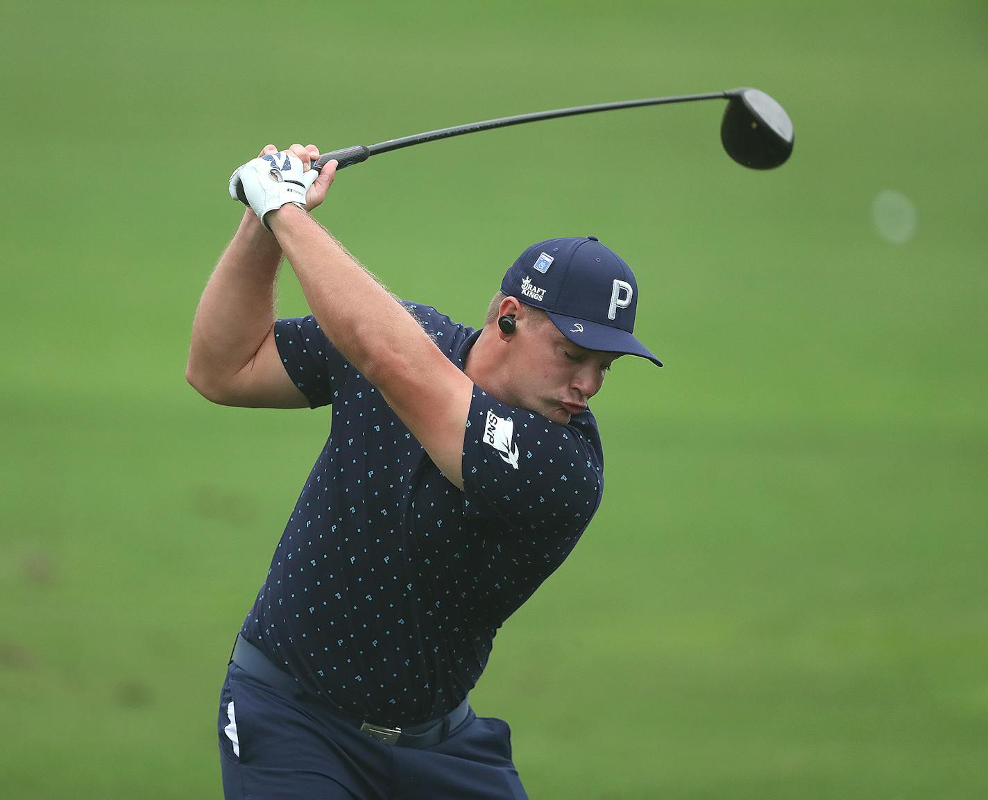 Bryson DeChambeau works on his driver during practice for the Masters