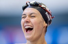 Natalie Sims is all smiles as she leaves the pool after she warmed up before the U.S. Paralympic swimming trials at the Jean K. Freeman Aquatic Center