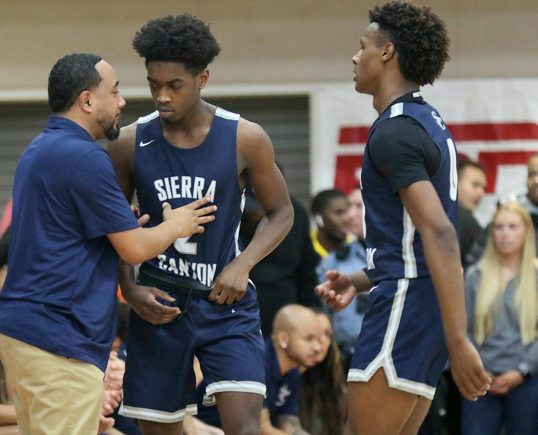Zaire Wade, middle, and Bronny James, right, of Sierra Canyon talk with a coach during a break in their game with The Patrick School Friday, Jan. 3, 2020, at Minnehaha Academy in Minneapolis MN.