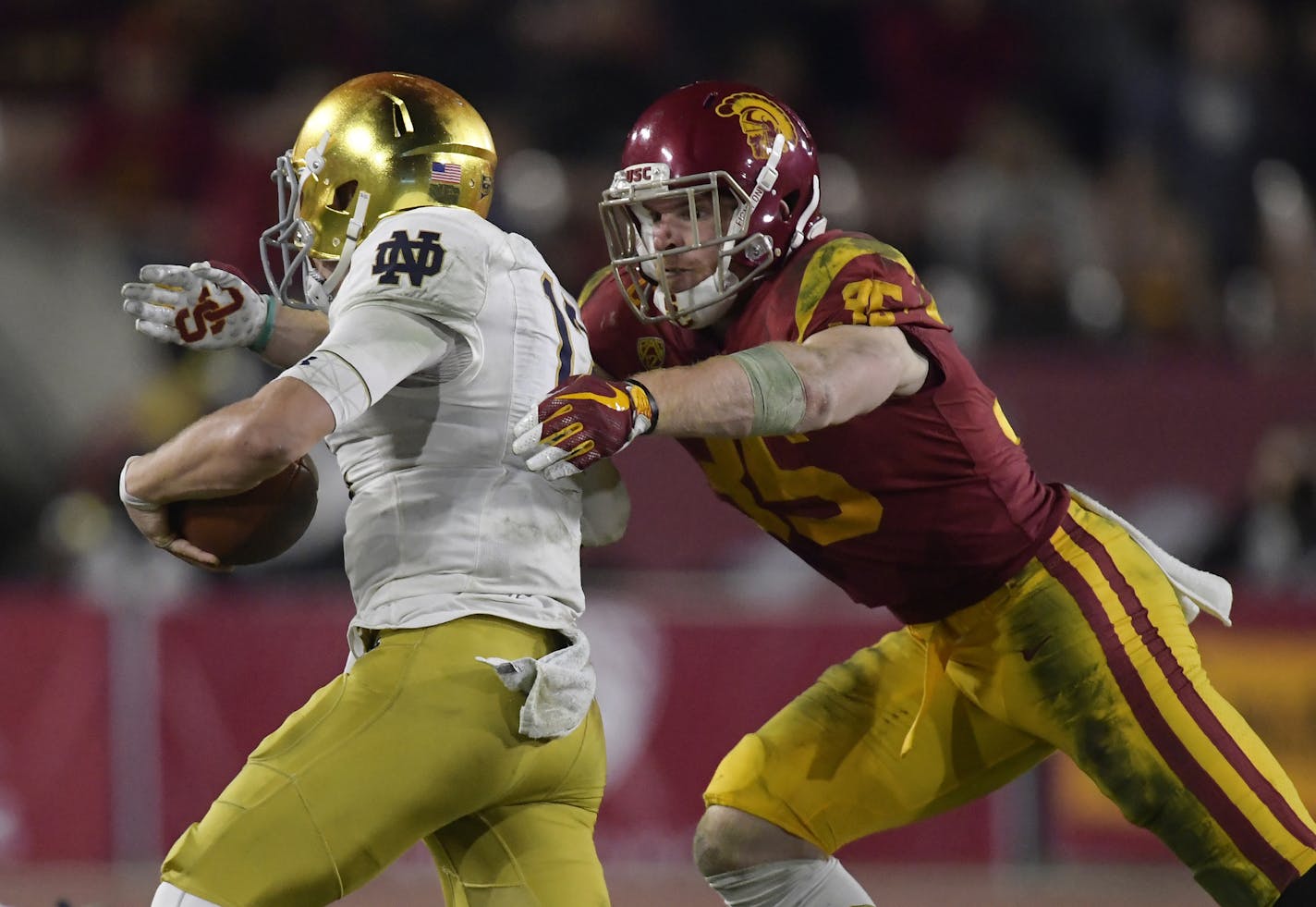 Southern California linebacker Cameron Smith, right, tackles Notre Dame quarterback Ian Book during the second half of an NCAA college football game Saturday, Nov. 24, 2018, in Los Angeles. Notre Dame won 24-17. (AP Photo/Mark J. Terrill) ORG XMIT: NYOTK