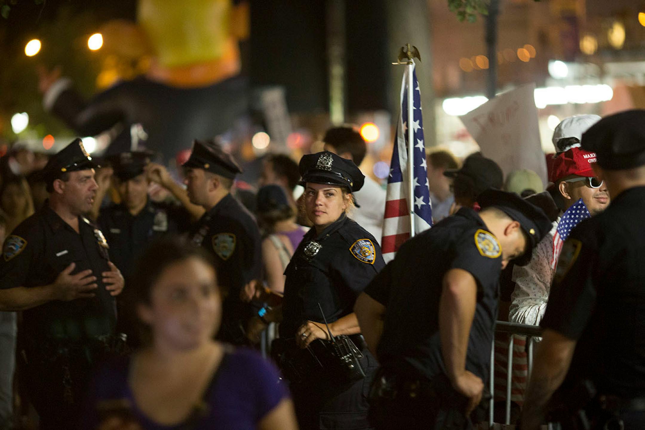 Police officers protect pro-Trump activists during dueling protests outside Trump Tower ahead of President Donald Trump's visit in New York, August 14, 2017. President Donald Trump is expected to spend Monday night at Trump Tower, his first visit to his Manhattan home since he was sworn in.