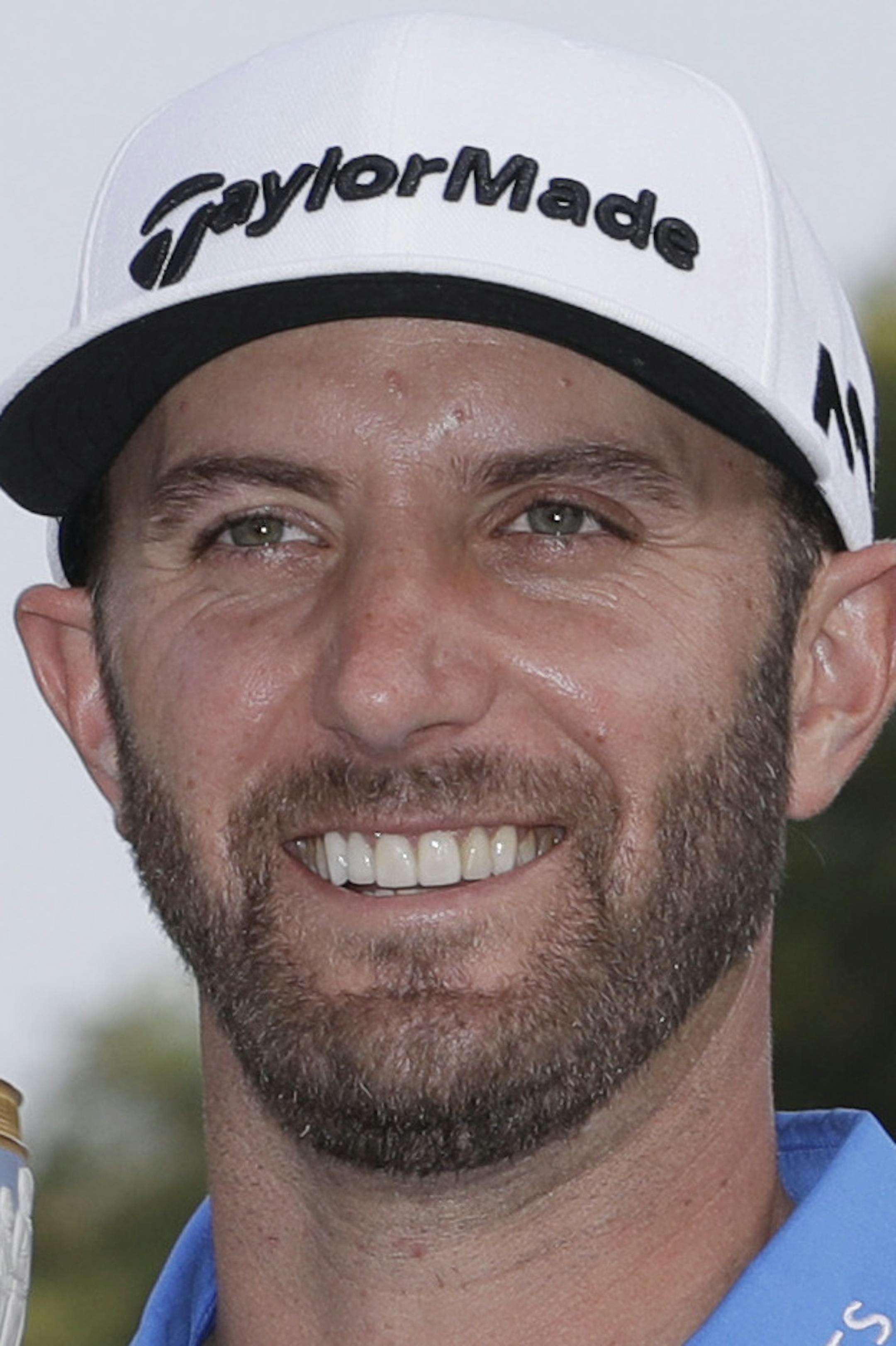 Dustin Johnson poses with his trophy after defeating Jon Rahm, of Spain, at the Dell Technologies Match Play golf tournament at Austin County Club, Sunday, March 26, 2017, in Austin, Texas. (AP Photo/Eric Gay)