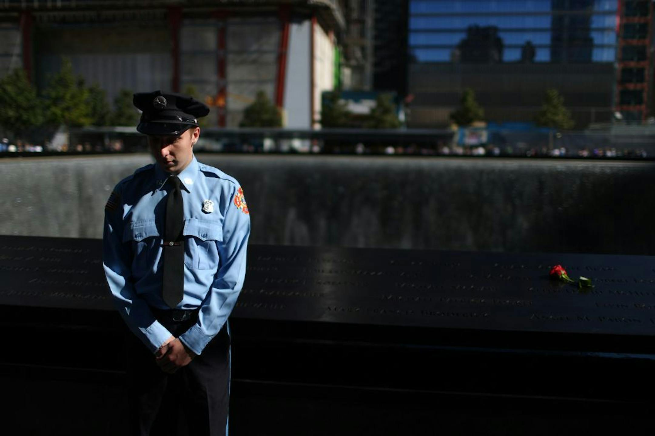 Zachary Ellicott pauses during a moment of silence at the observance of the 11th anniversary of September 11th at the National September 11 Memorial in New York on Tuesday, Sept. 11, 2012.