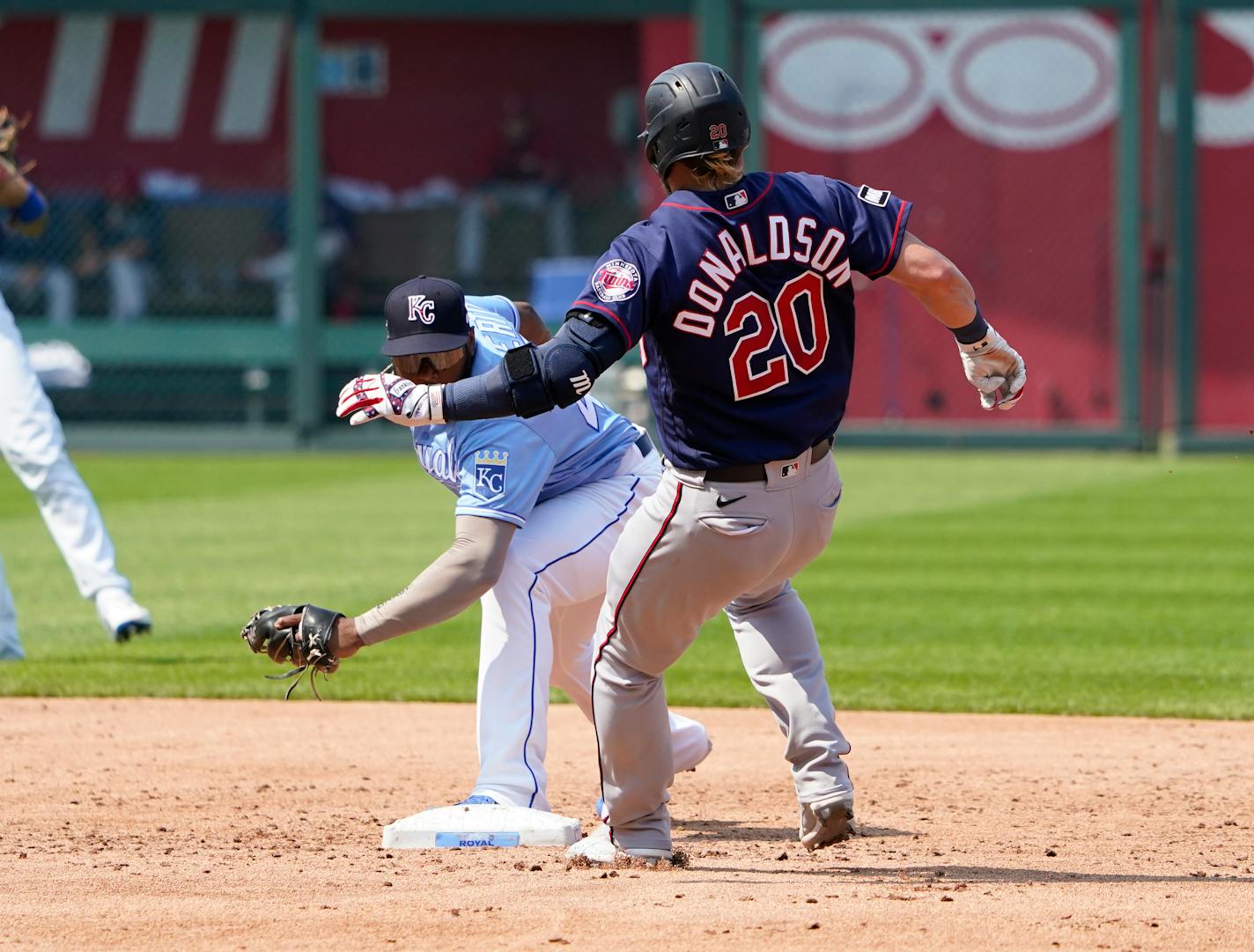 Minnesota Twins' Josh Donaldson (20) beats the tag by Kansas City Royals second baseman Hanser Alberto for a double in the third inning during a baseball game Saturday July 3, 2021, in Kansas City, Mo. (AP Photo/Ed Zurga)