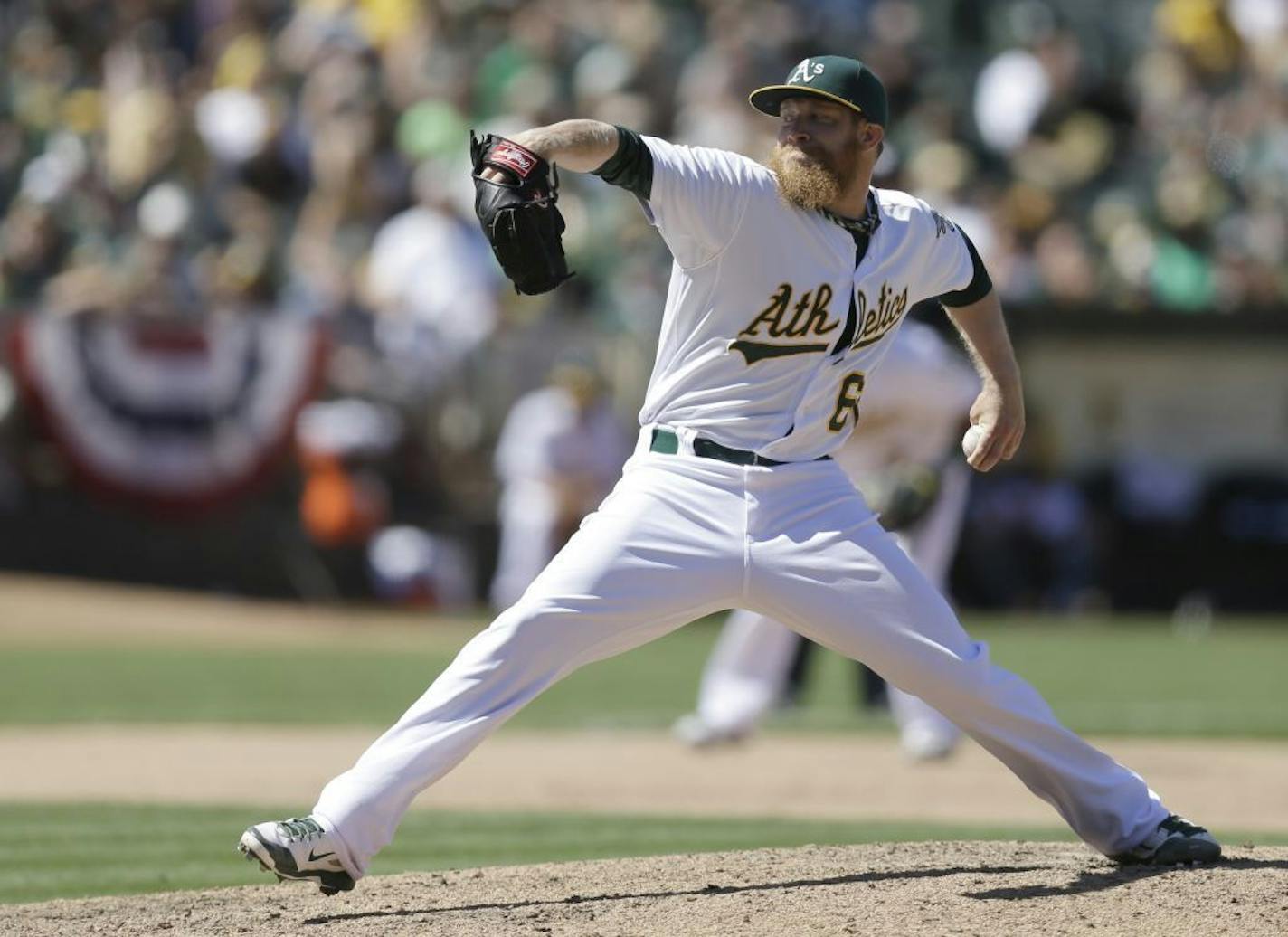 Oakland Athletics' Sean Doolittle works against the Toronto Blue Jays in the ninth inning of a baseball game Sunday, July 6, 2014, in Oakland, Calif.