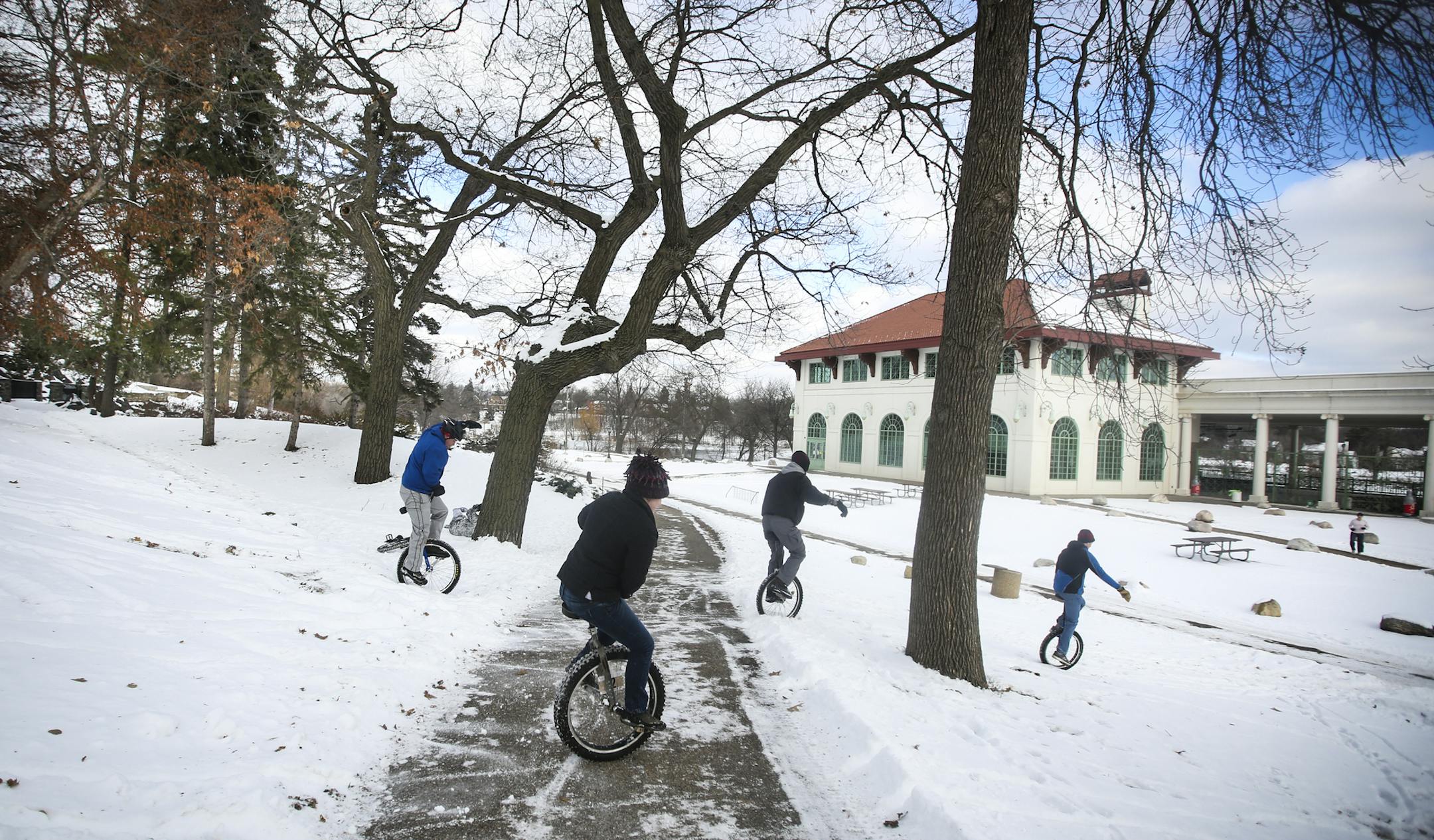 Unicyclists rode off-rode together down a hill during the Twin Cities Unicycle Club annual New Yeard Day "Tundracon" ride at Lake Como on Thursday, January 1, 2015 in St. Paul, Minn. ] RENÉE JONES SCHNEIDER reneejones@startribune.com From the the left; Joe Lind, Tess Macey, Matt Sindelar, and Bruce Lee.