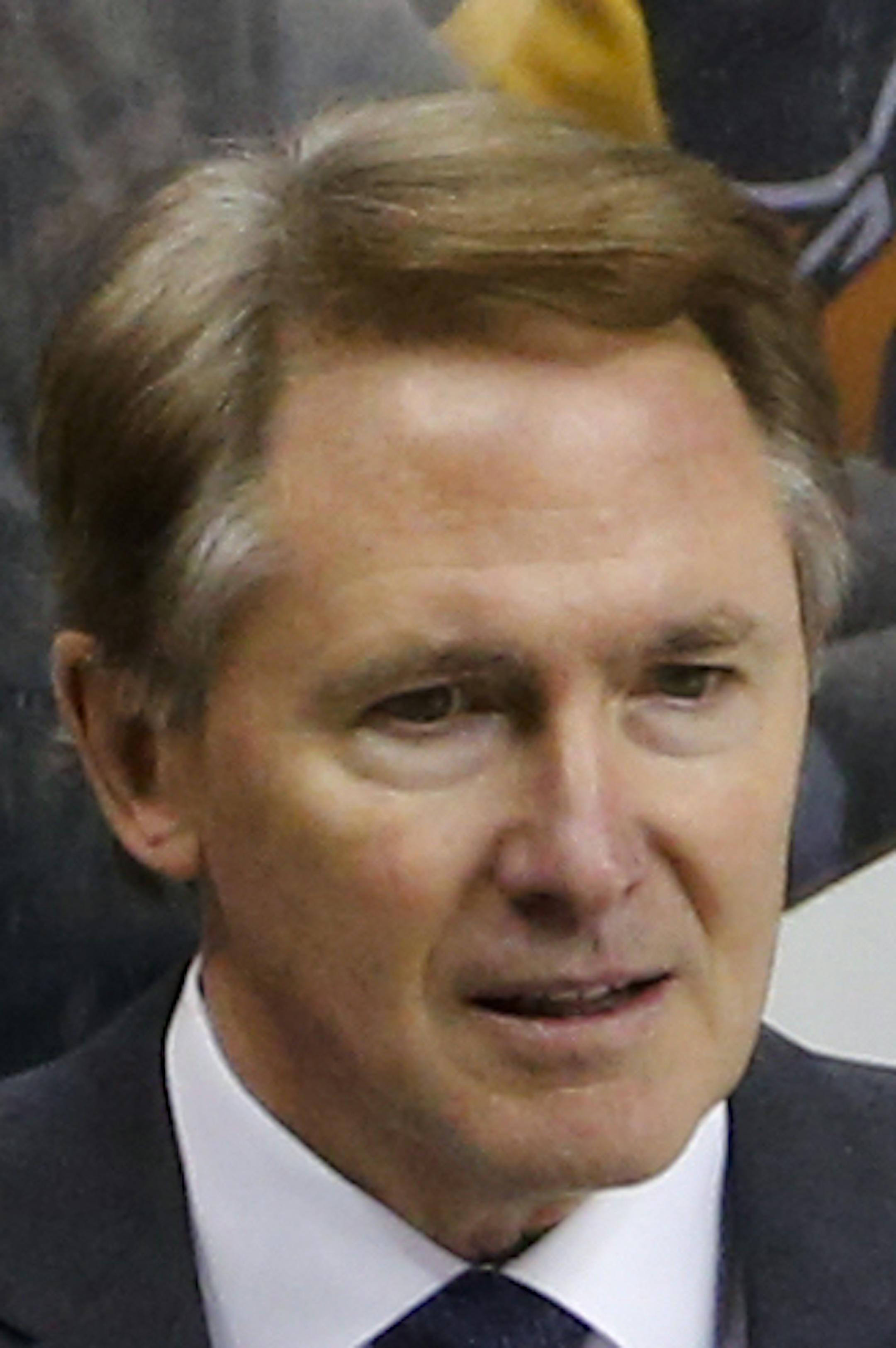 Pittsburgh Penguins' head coach Mike Johnston stands behind his bench during an NHL hockey game against the Los Angeles Kings in Pittsburgh Friday, Dec. 11, 2015. The Kings won 3-2 in a a shootout. (AP Photo/Gene J. Puskar)