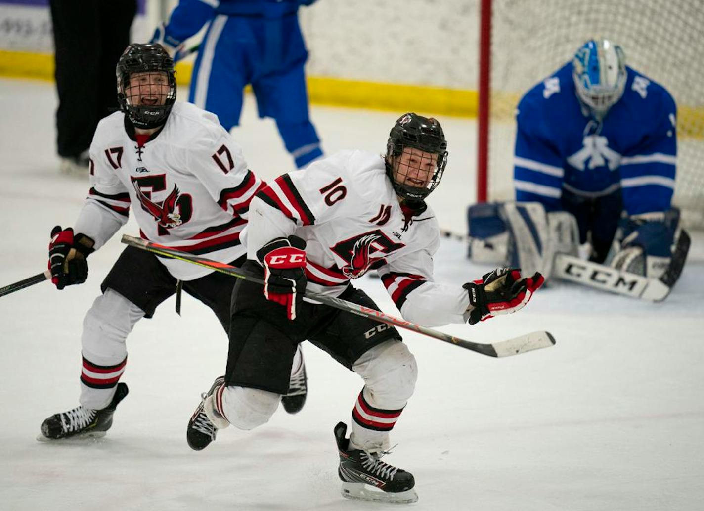 Phil Feinberg (10), with Jake Luloff (17) skated to the Eden Prairie fans to celebrate his game winning goal in overtime to send the Eagles to the State Tournament. ] JEFF WHEELER • jeff.wheeler@startribune.com