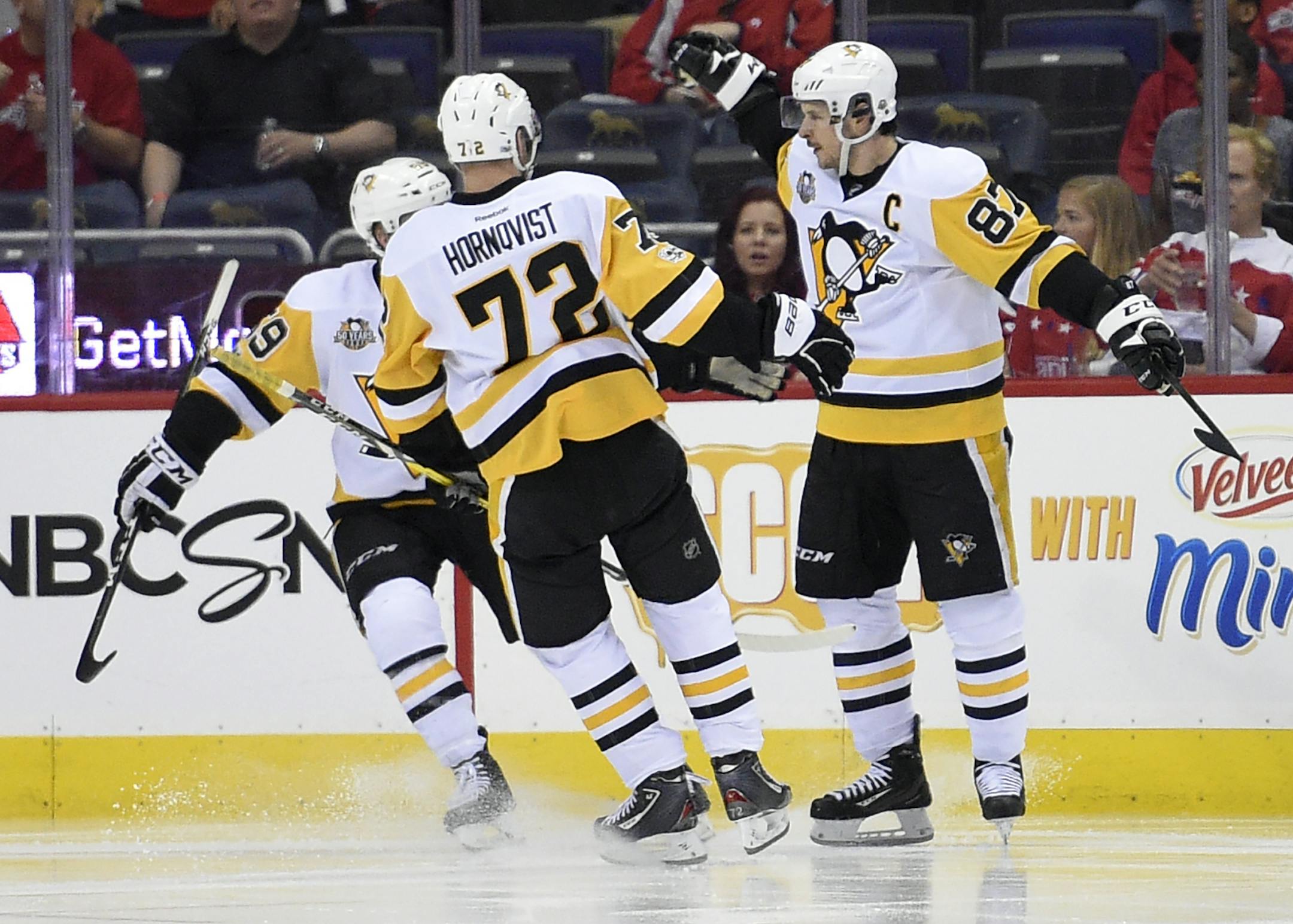 Pittsburgh Penguins center Sidney Crosby (87) celebrates his goal with Patric Hornqvist (72), of Sweden, and Jake Guentzel (59) during the second period of Game 1 of an NHL hockey Stanley Cup second-round playoff series against the Washington Capitals, Thursday, April 27, 2017, in Washington. (AP Photo/Nick Wass)