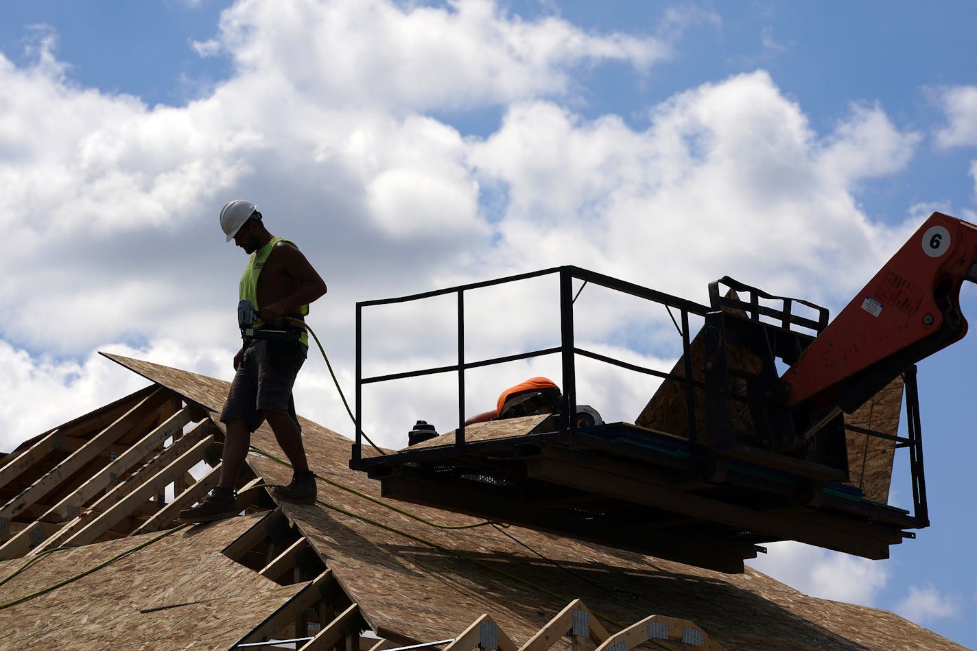 Crews worked on the roof of a home under construction in the Bailey Meadows development Friday in Newport. ] ANTHONY SOUFFLE • anthony.souffle@startribune.com Construction crews worked on several single family home developments Friday, July 31, 2020 in Newport, Minn.