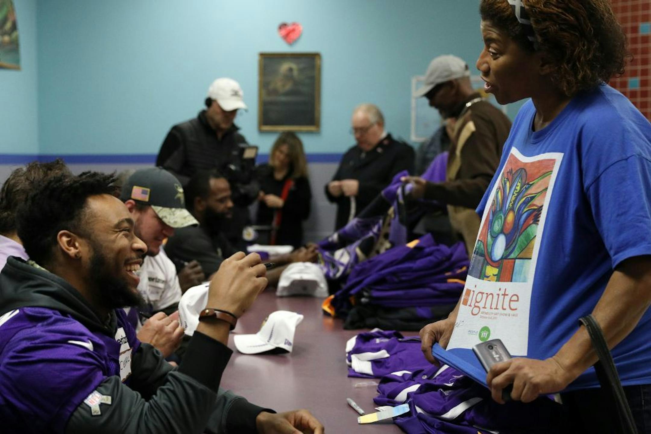 Minnesota Vikings safety Cedric Thompson laughed as Tracy Woods asked him to sign her shirt Tuesday.